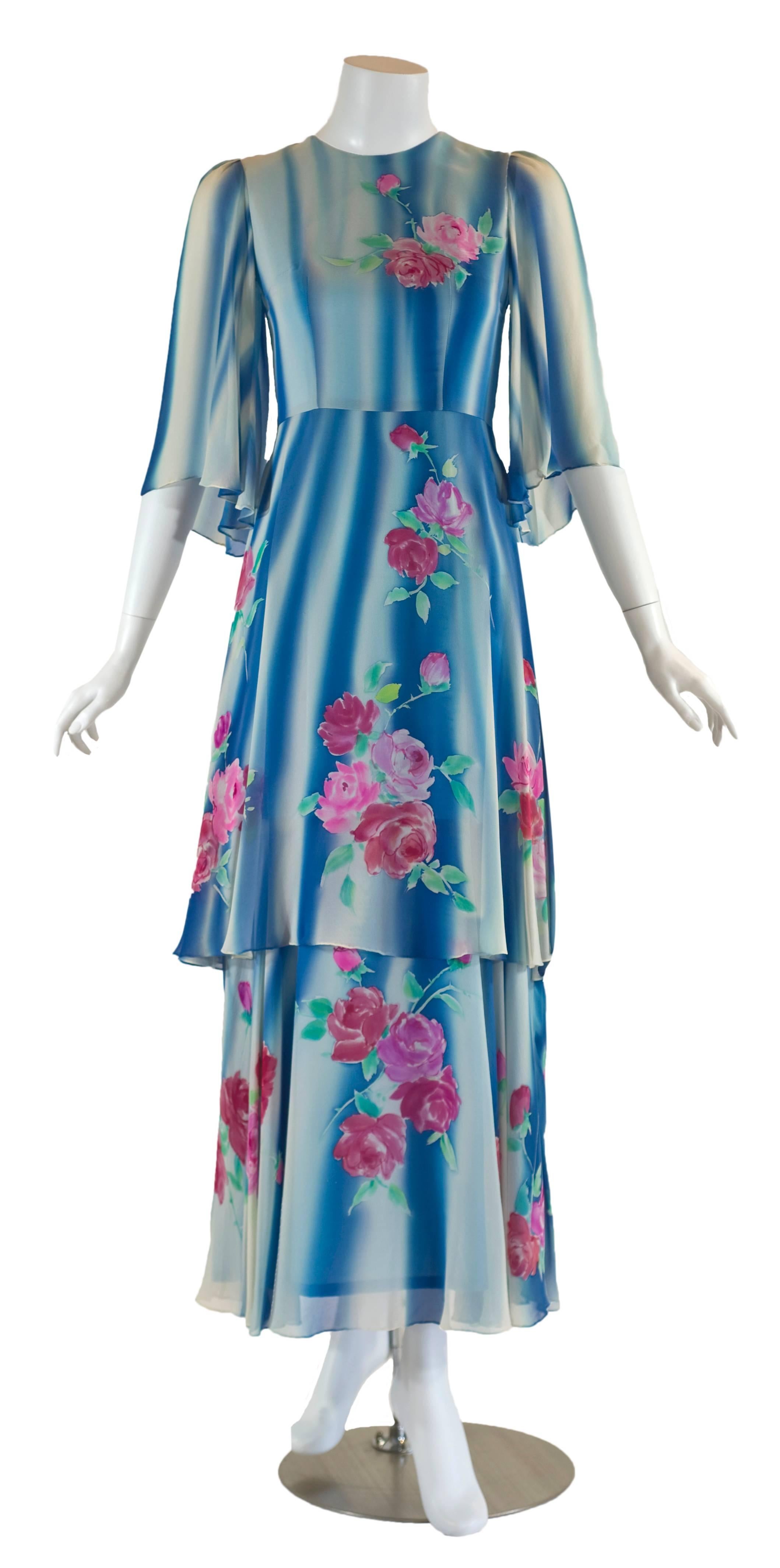Bright colors, and the floral print were staple design elements in poplar 1970s fashion popularized by the rise of countercultural movements notably the hippies. The use of light weight fabrics to form wide silhouettes revived the aesthetic dress