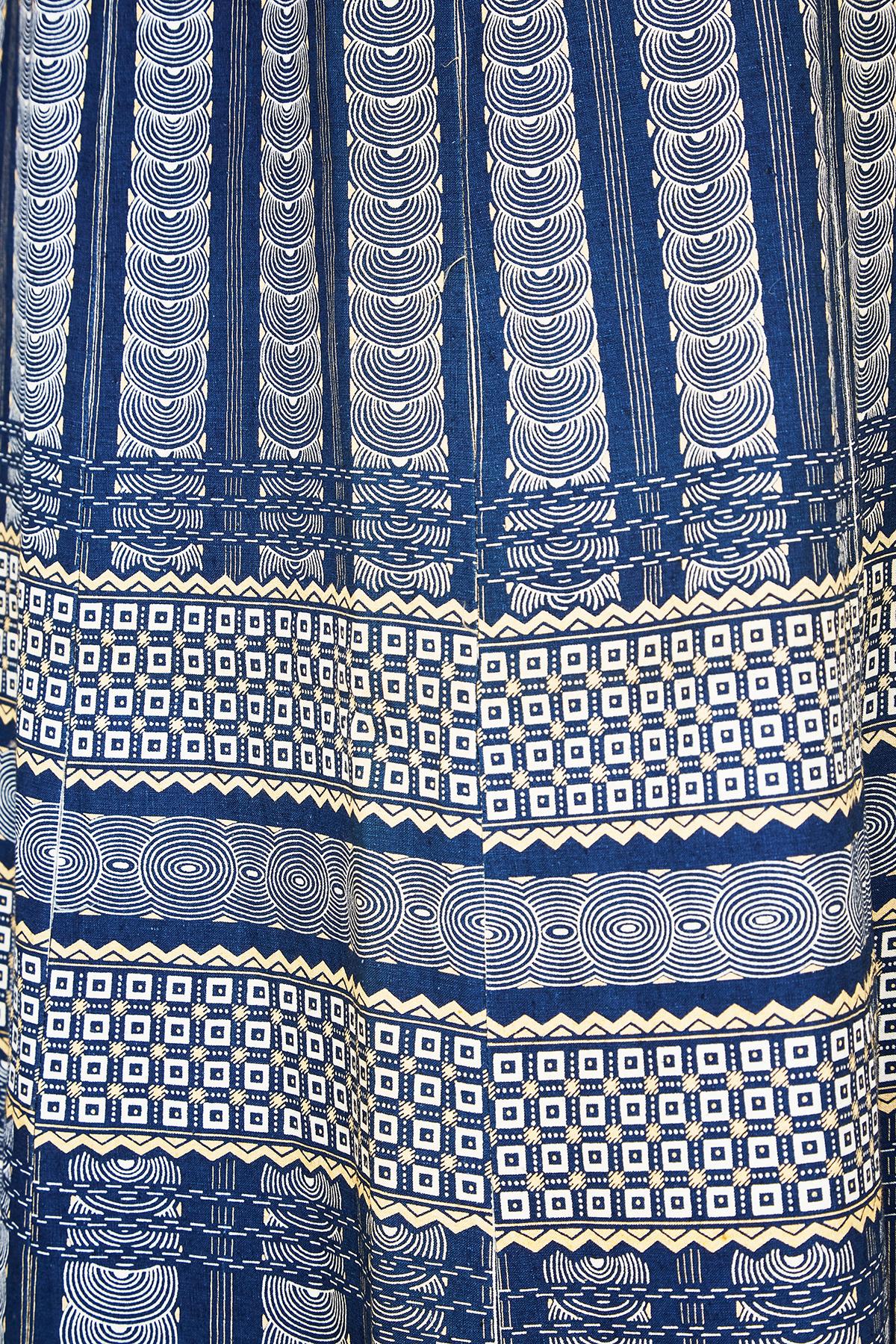 Superb print and tailoring on this ankle length original 1970s maxi skirt.  The waist and hem flounce feature a pixilated diamond pattern but the real star of the show is the geometric deco print interspersed with two wide horizontal band of squares