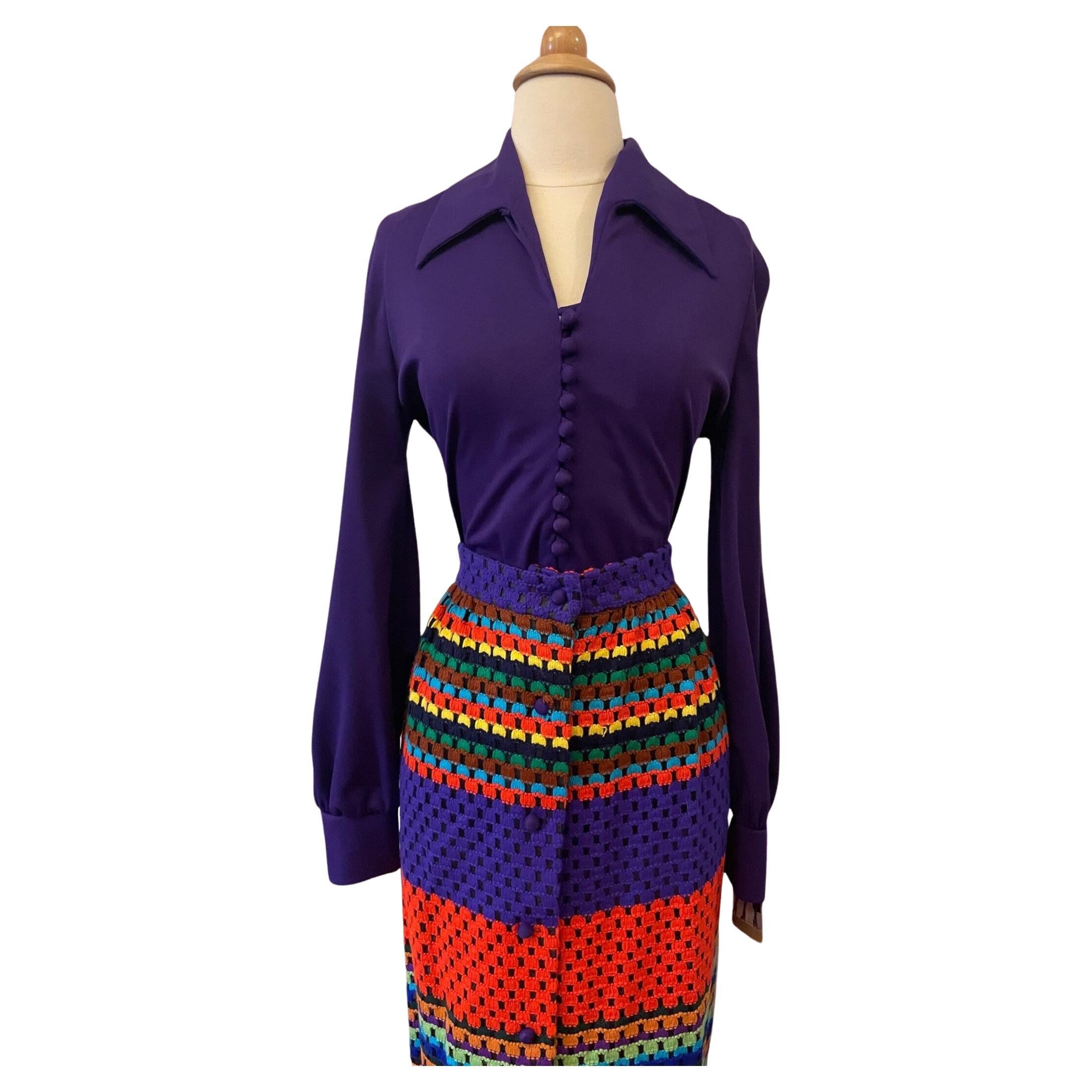 vintage two-piece bodysuit & maxi skirt set. long sleeve collared bodysuit with deep v neckline. round self fabric buttons along the bodice. color blocked horizontal stripe skirt. open weave machine crochet yarn in rainbow shades of purple, red,