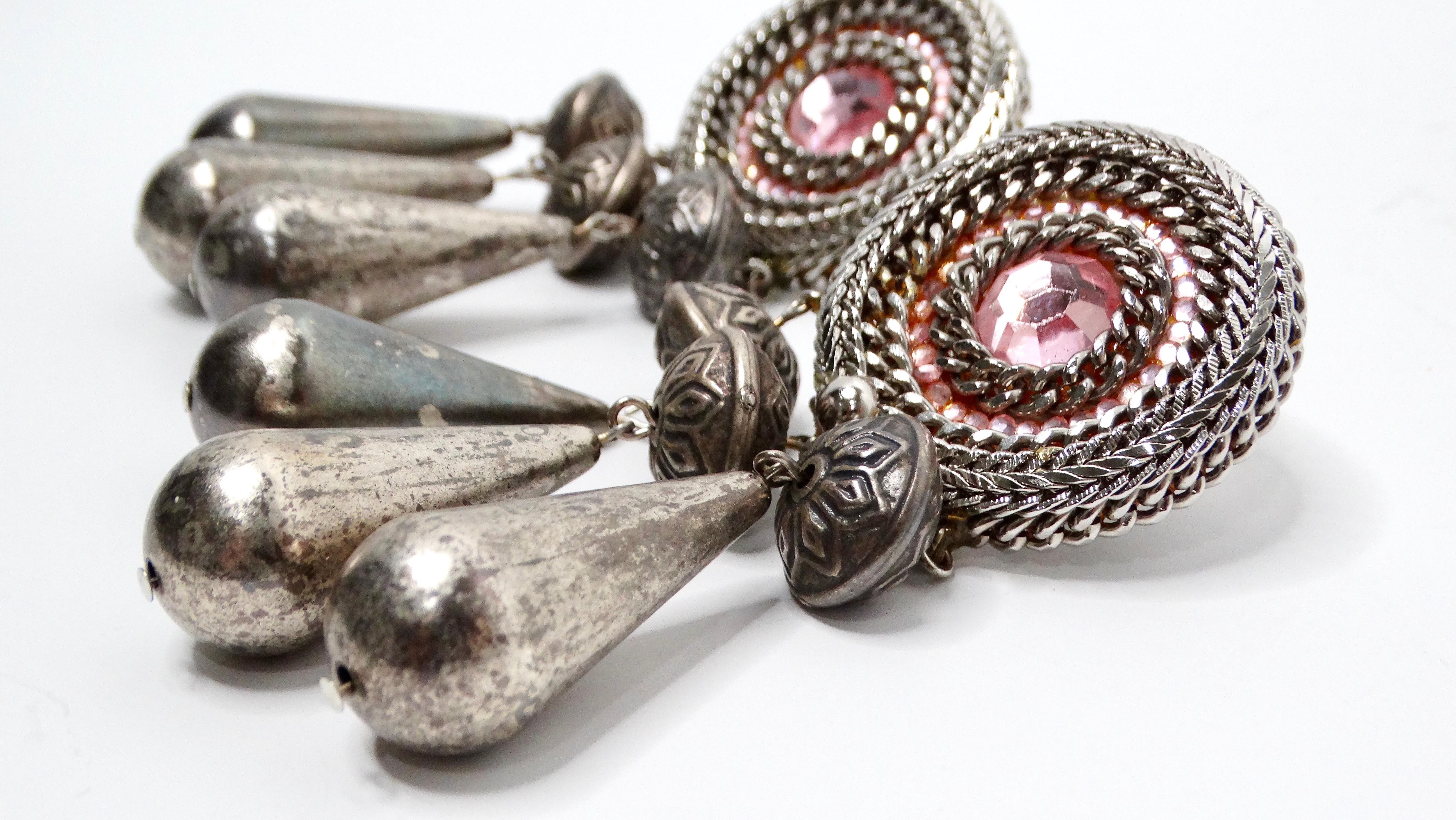Introducing the stunning 1970s Bohemian Tassel Pink Sterling Silver Plated Dangle Earrings, an exquisite statement piece reminiscent of dream catchers, perfect for adding a touch of vintage elegance to any outfit. These eye-catching earrings feature