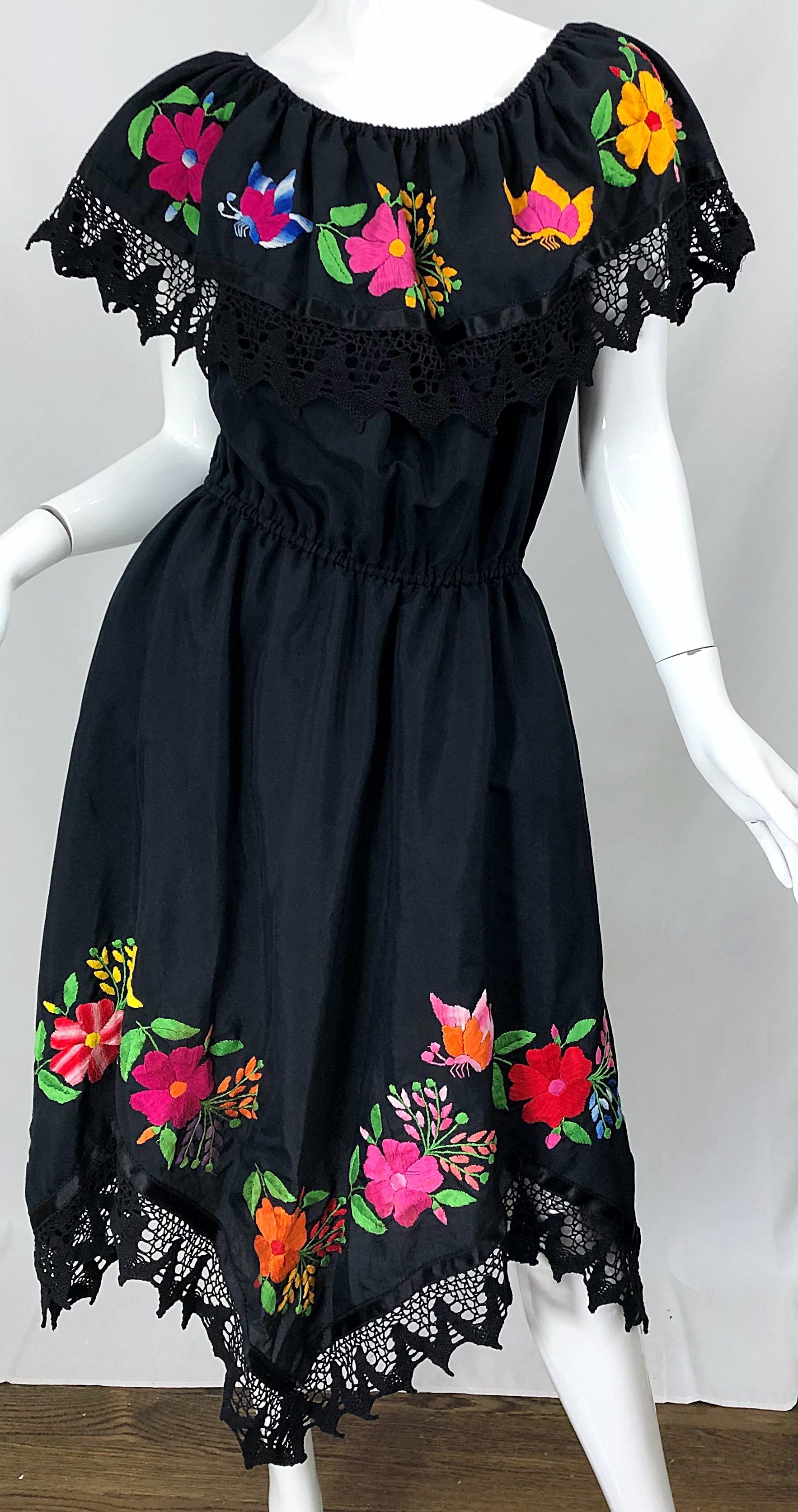 Boho chic 1970s / 70s black cotton embroidered Spanish style dress! The beauty about this dress is that it can be worn two ways, as pictured. It can be worn on or off the shoulders, and looks equally as good either way. Bright flowers in pink,
