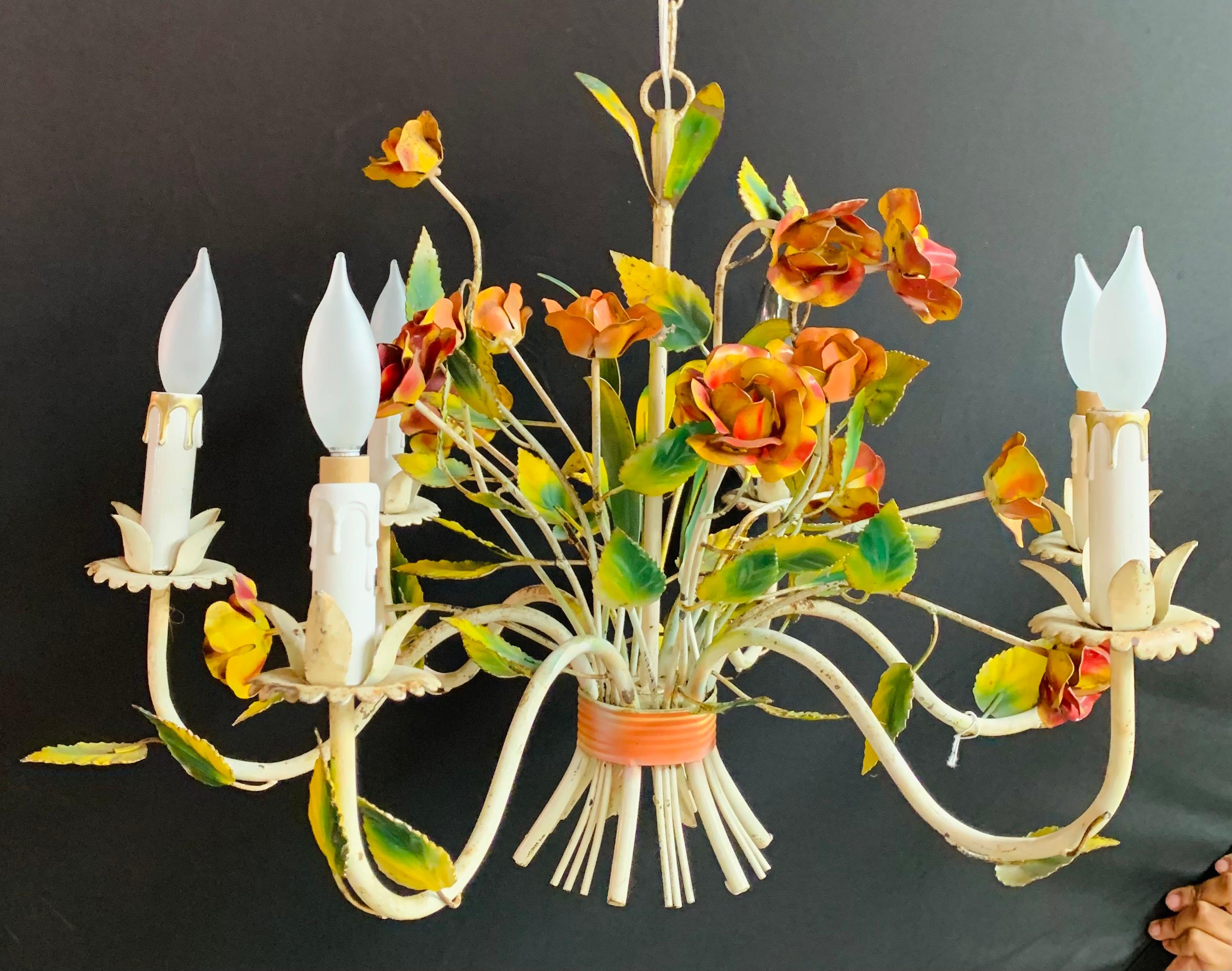 This cheerful Italian boho chic tole metal hand painted chandelier with six arms will bring light and style to any living space. Skillfully handcrafted of tole metal in the shape of beautiful flowers bouquet and hand painted in green, orange/