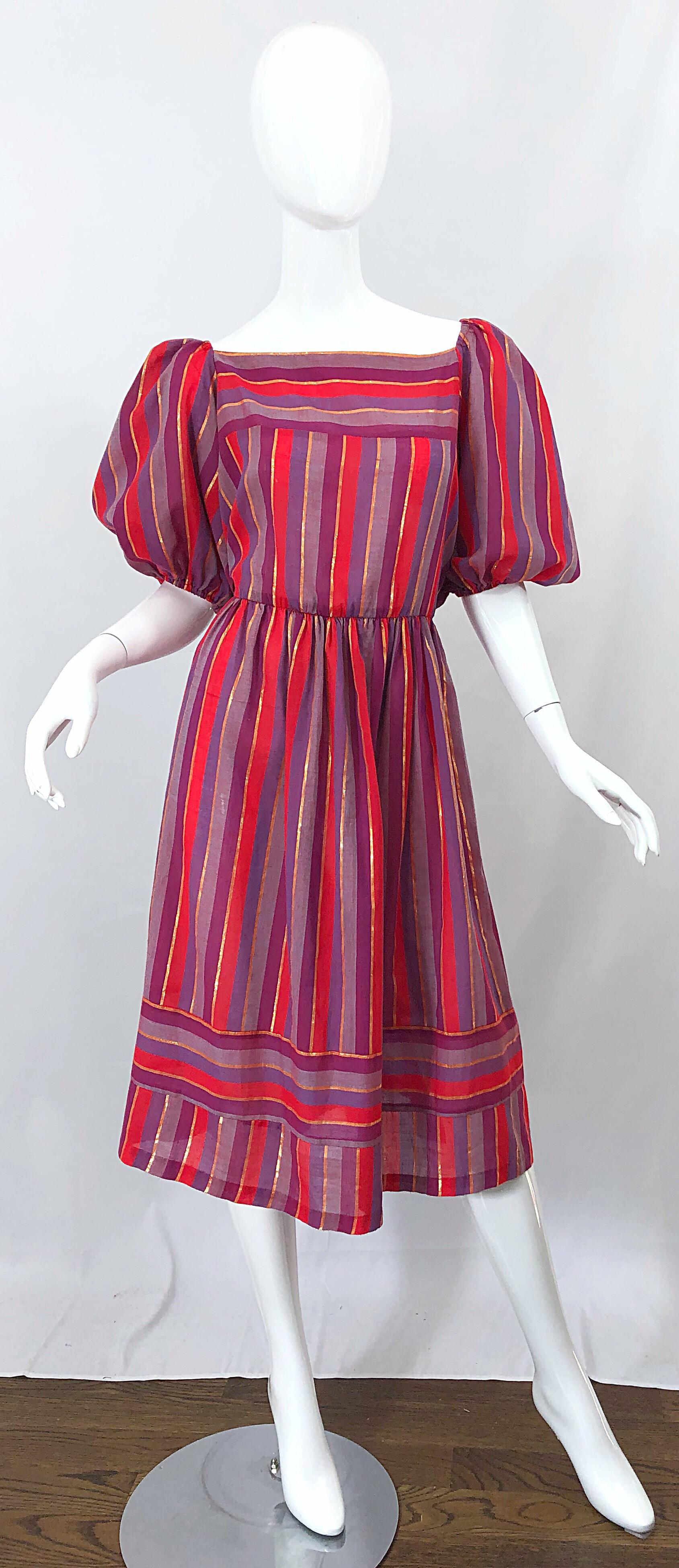 Boho chic 1970s red, purple lilac and metallic gold vertically striped dress! Features chic short puff sleeves. Elastic waistband makes this beauty easy to wear and comfortable. Lightweight cotton voile blend is perfect for any time of year. Hidden