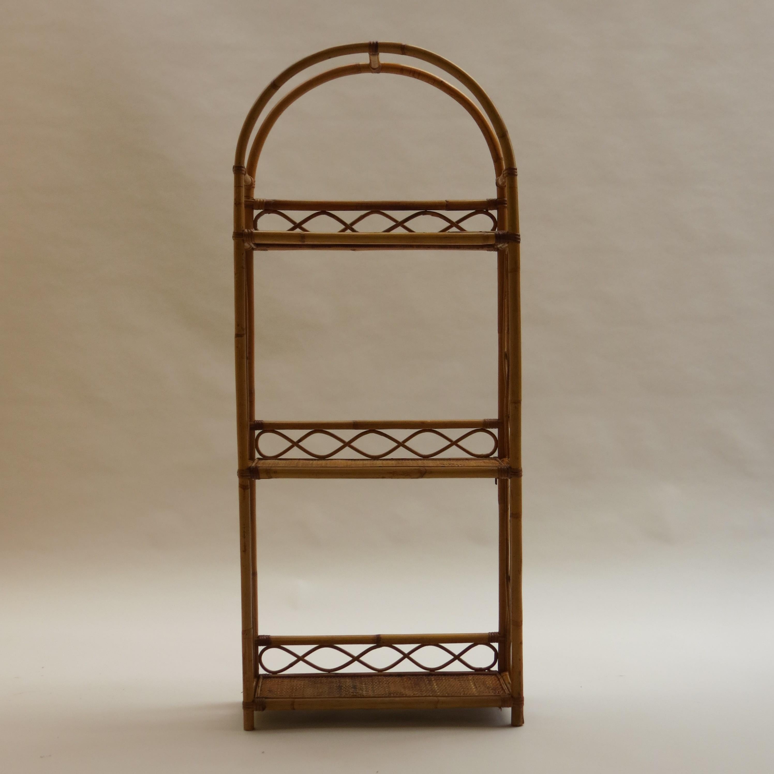 A 1970s cane and bamboo bookcase shelving unit with good decorative cane work. A good storage shelving unit, wonderful warm color and nicely patinated. 

ST1227.

 