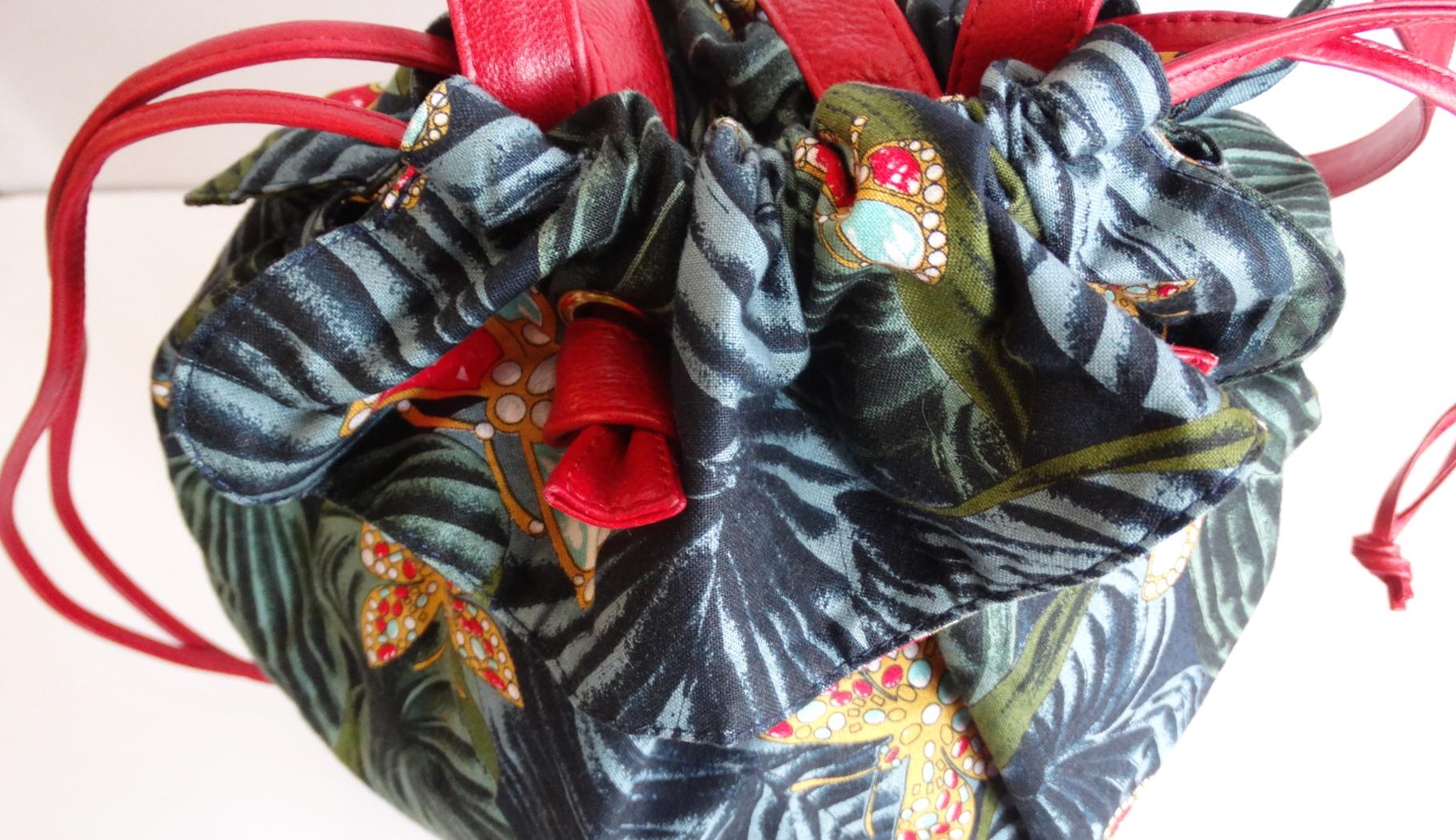 Always Be Ready For Vacation With This Bottega Veneta Bag! Circa 1970s, this cotton bucket bag features a dark tropical greenery pattern with contrasting gold and rhinestone butterflies scattered throughout. Includes a small ruffle detail around the