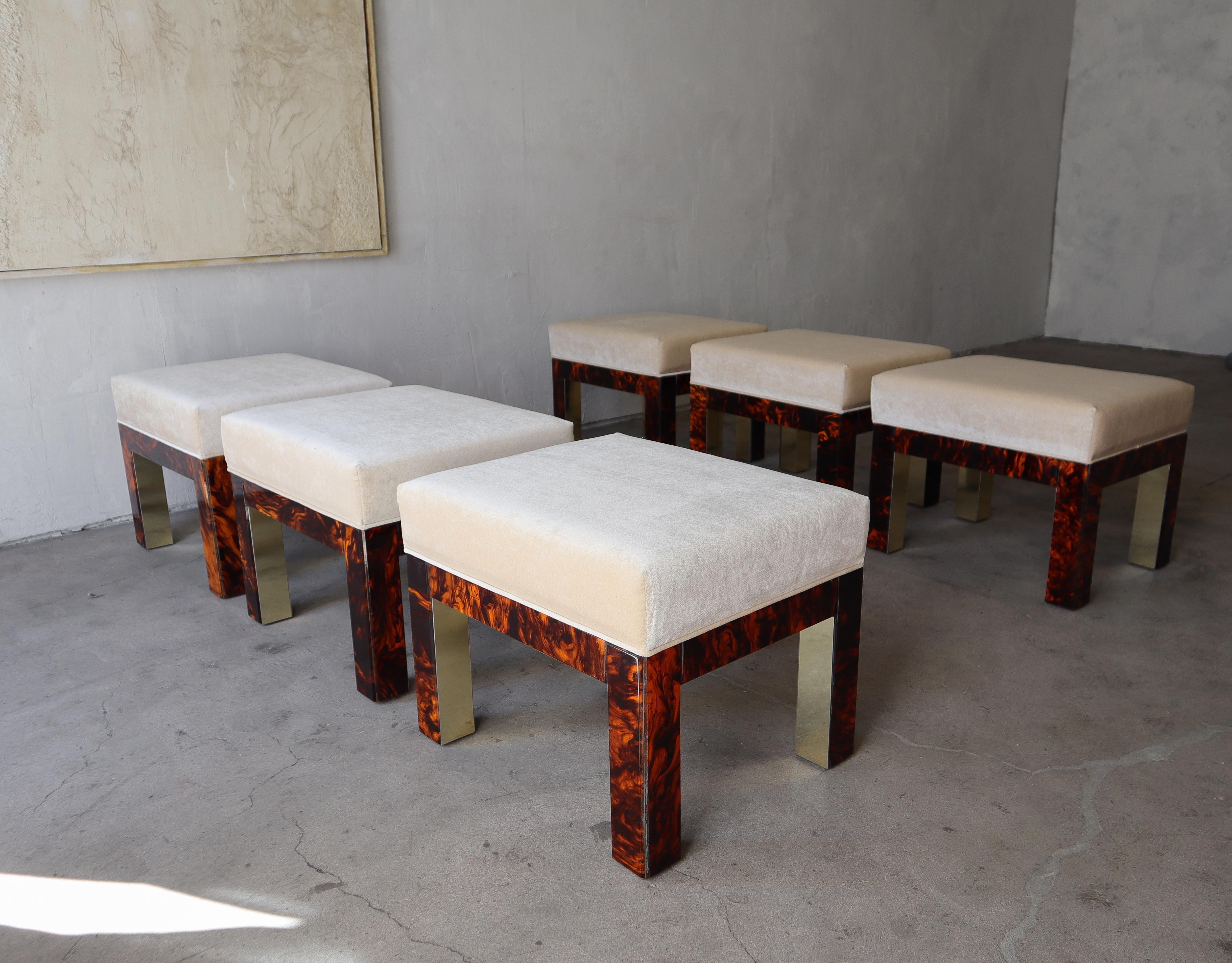 Rare and unique set of 6, 1970's low stools that can alternately be used as ottomans.  Constructed of tortoise shell Bakelite and solid brass with all new cream velvet seats.  This set is the epitome of designer and class.  They have a true upper