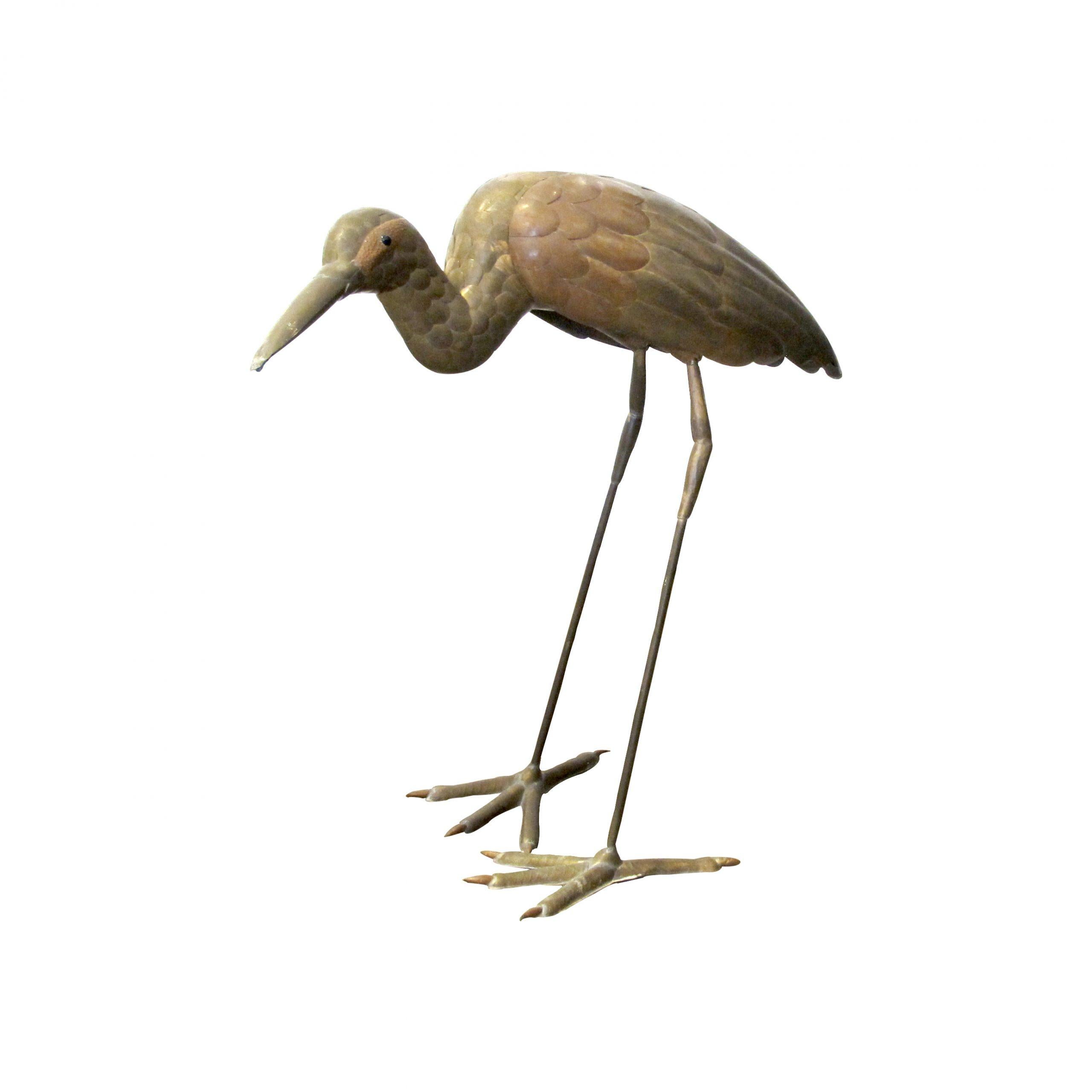 A tall free-standing life-size brass and copper sculpture of a heron by Mexican artist Sergio Bustamante, 1970’s. 
Size: H65 cm x W70 cm x D30 cm

Artist biography:
Bustamante's first art exhibition showcased paintings and papier-mâché figures at