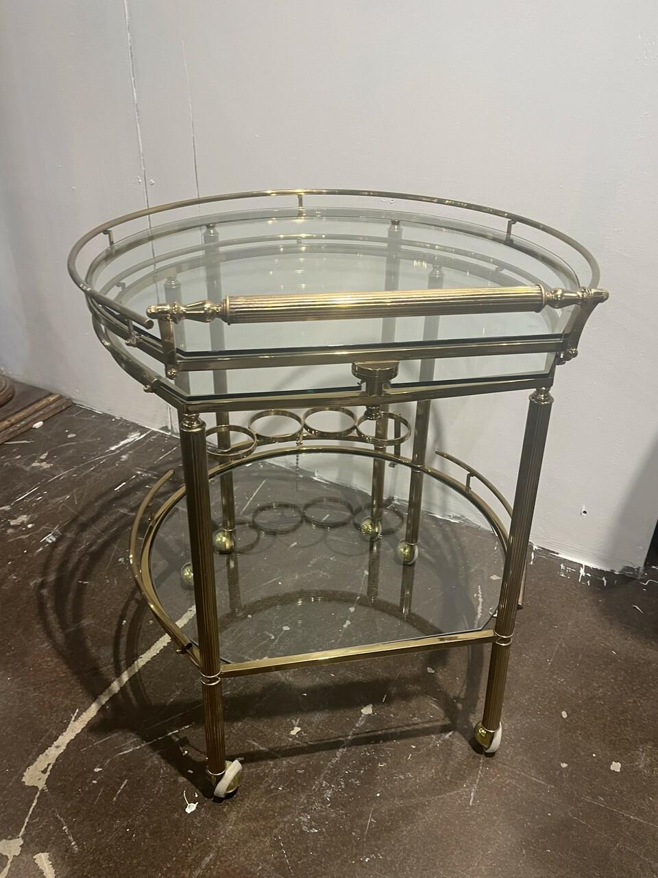 1970's Brass and Glass 3 tier Bar Cart Server. Has unique swing out design for more serving area. Sits on smooth rolling casters.