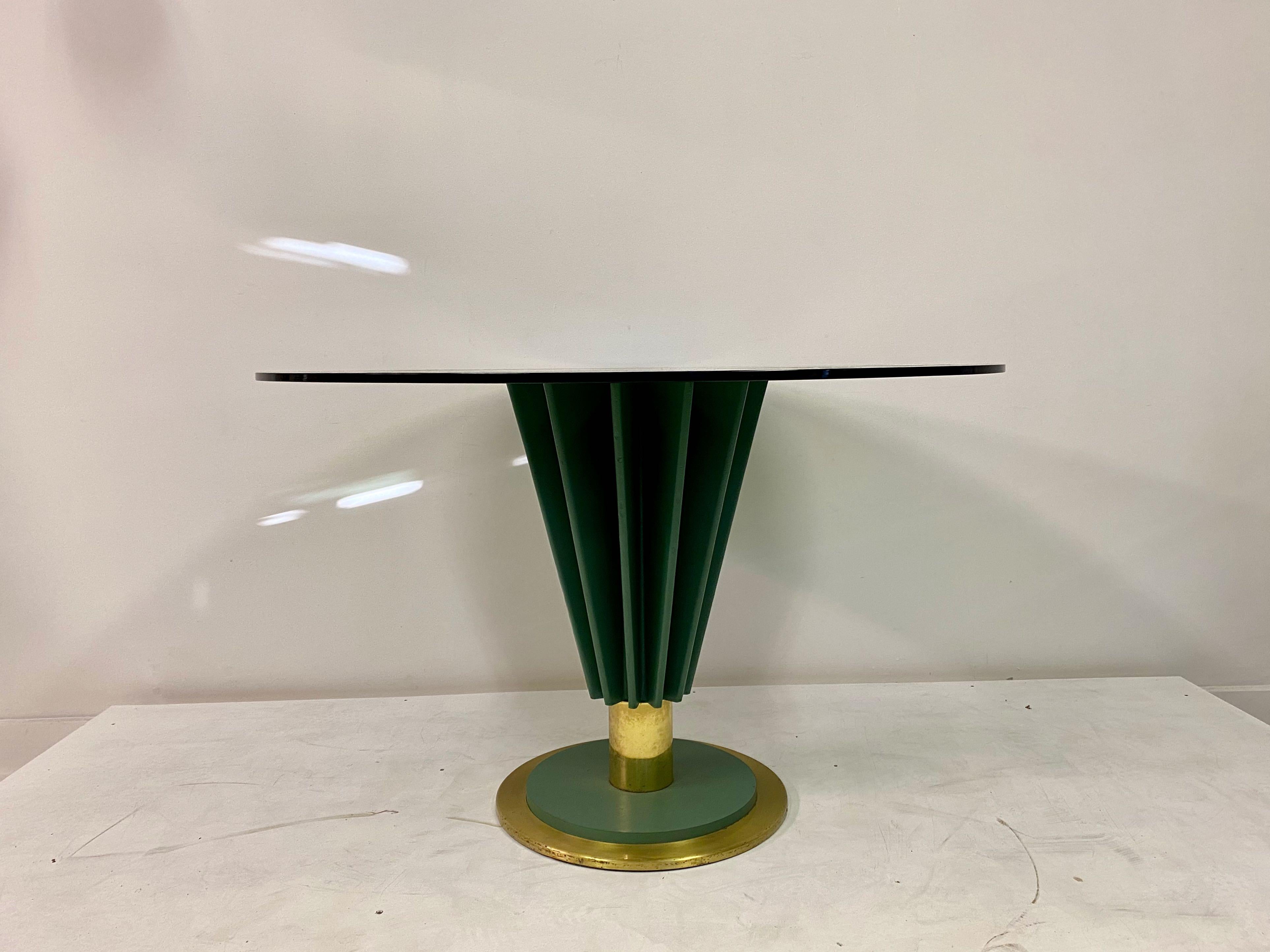 Dining table

By Pierre Cardin

One green pedestal

Round smoked glass top

Iron and brass base

Signed

1970s Italian

Glass size and color can be changed on request

Two available.