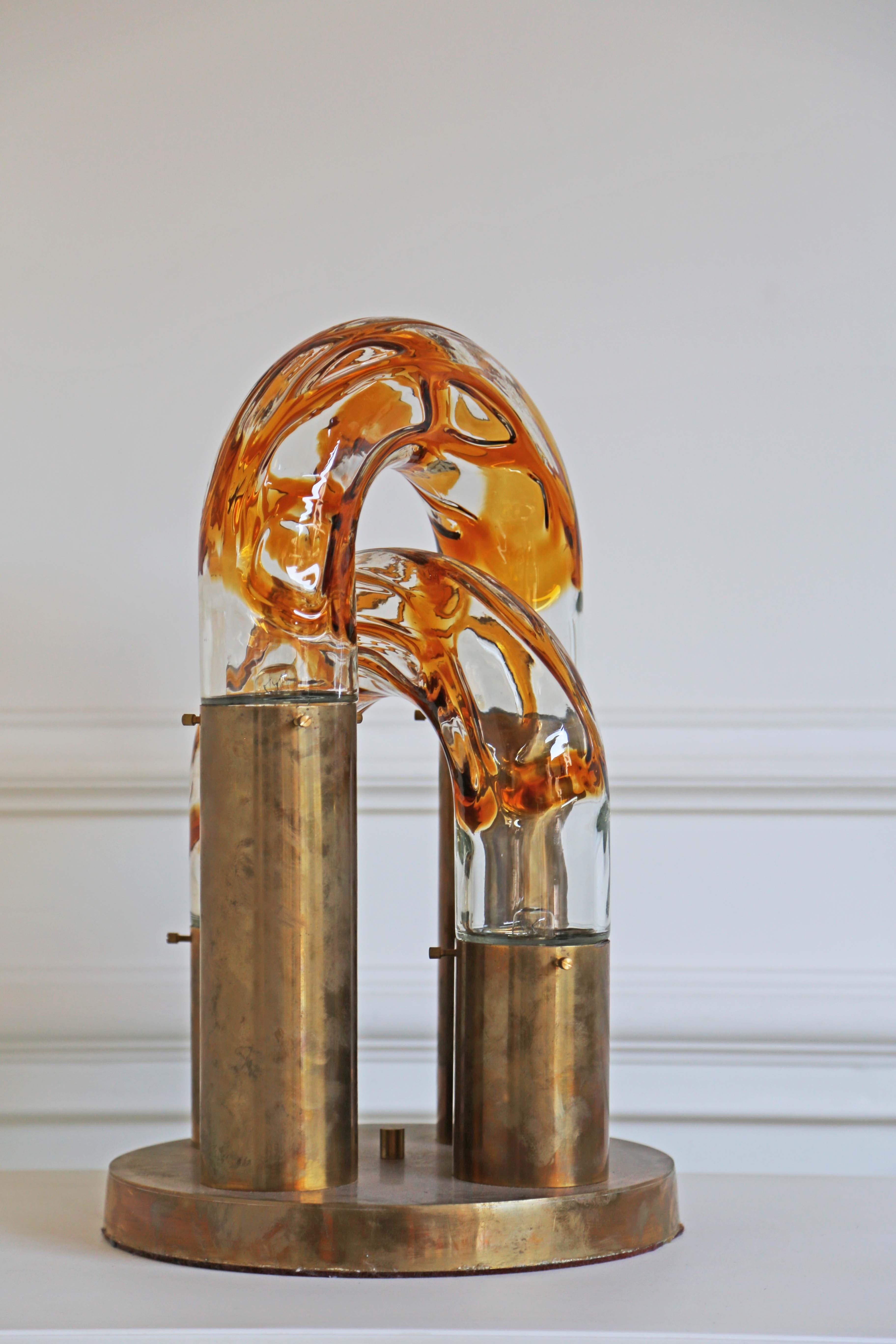 1970s Brass and Murano Glass Table Lamp
Table lamp by the designer Aldo Nason for the manufacture Mazzega Murano. 
Caramel blown glass brass base, nice patina. 
UK Wired 


