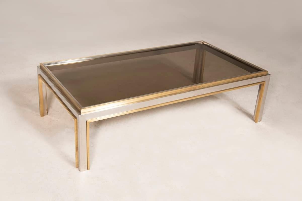 Coffee table with semi-transparent smoked glass top and brass and steel frame from the 1970s. 

Measurements 70 x 130 x H 37 cm

Price INCLUDES the costs for any packaging and crates needed to protect the item and keep the item stable during any