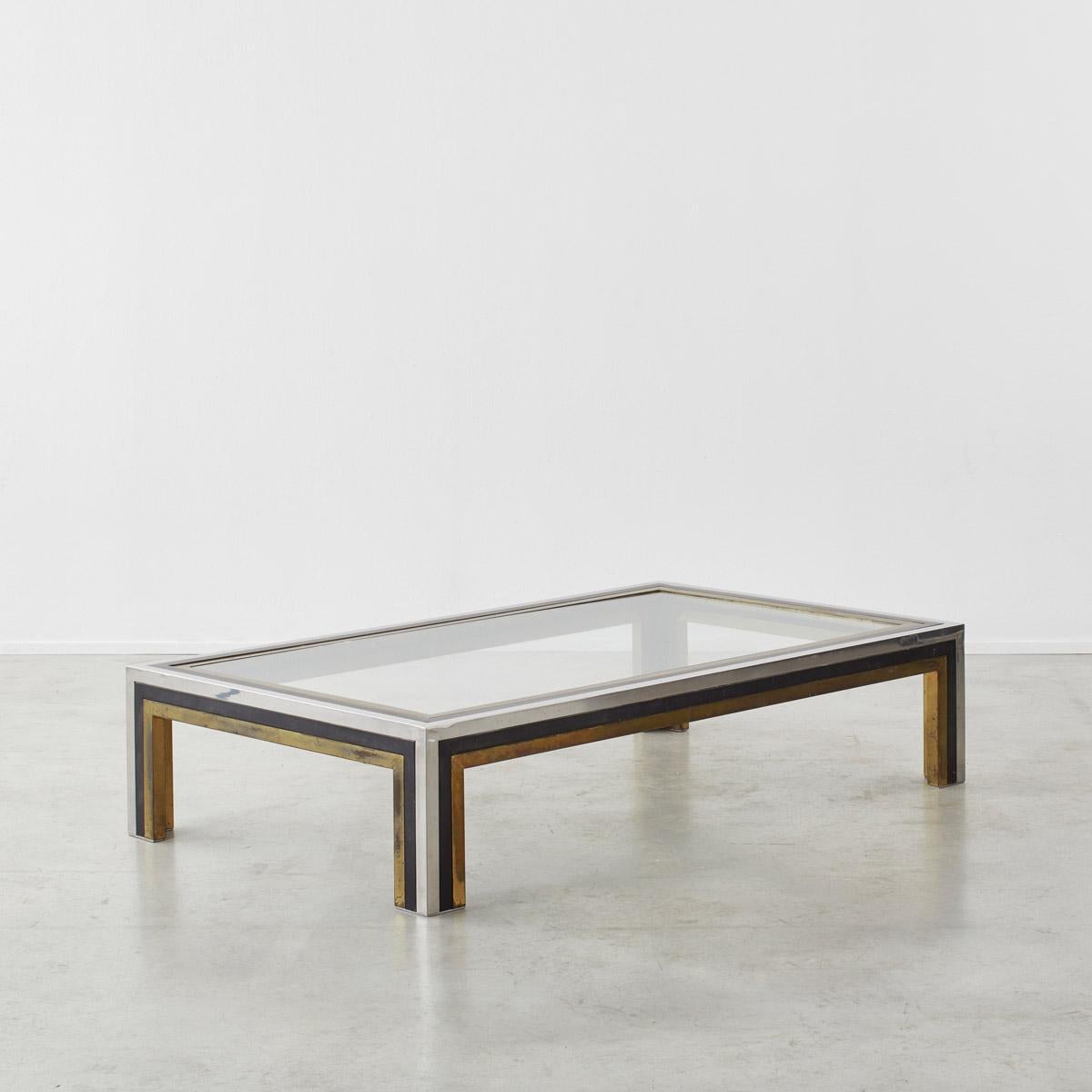 A beautiful, rectangular coffee table in smoked thick plate glass with a striped rim of brass, black lacquer and chrome plate. The coffee table sits at the more refined and minimal end of Hollywood Regency style. These tables attributed to Romeo