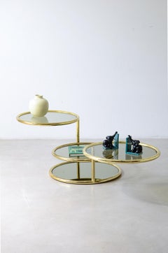 1970's brass coffee table with four circular tops in lig