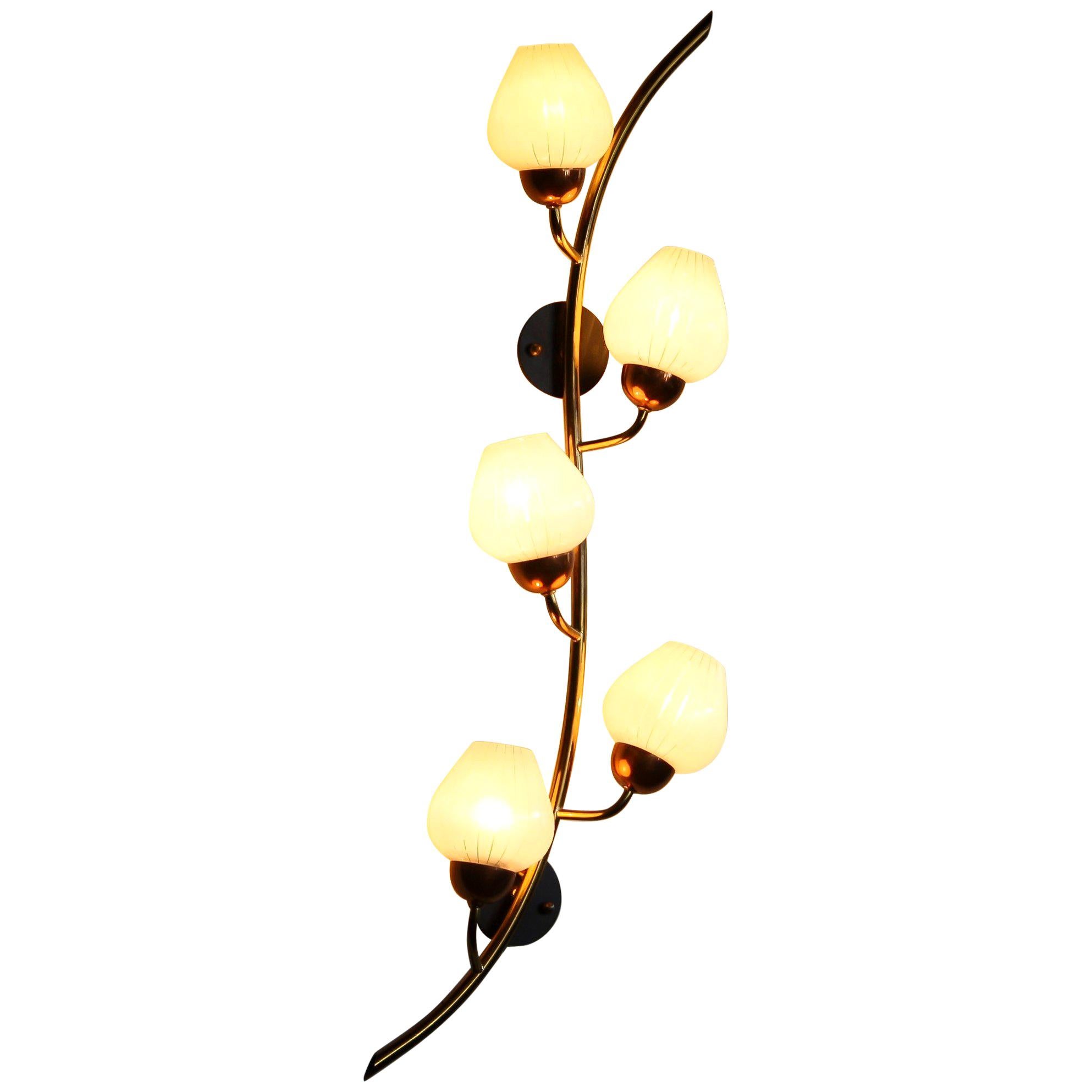 Beautiful brass wall light from Sweden.
This lamp consists of a copper base with five white glass shades like a branch with berries.
The shades have transparent lines making it a nice shining light.
The lamp is in a very nice and functional