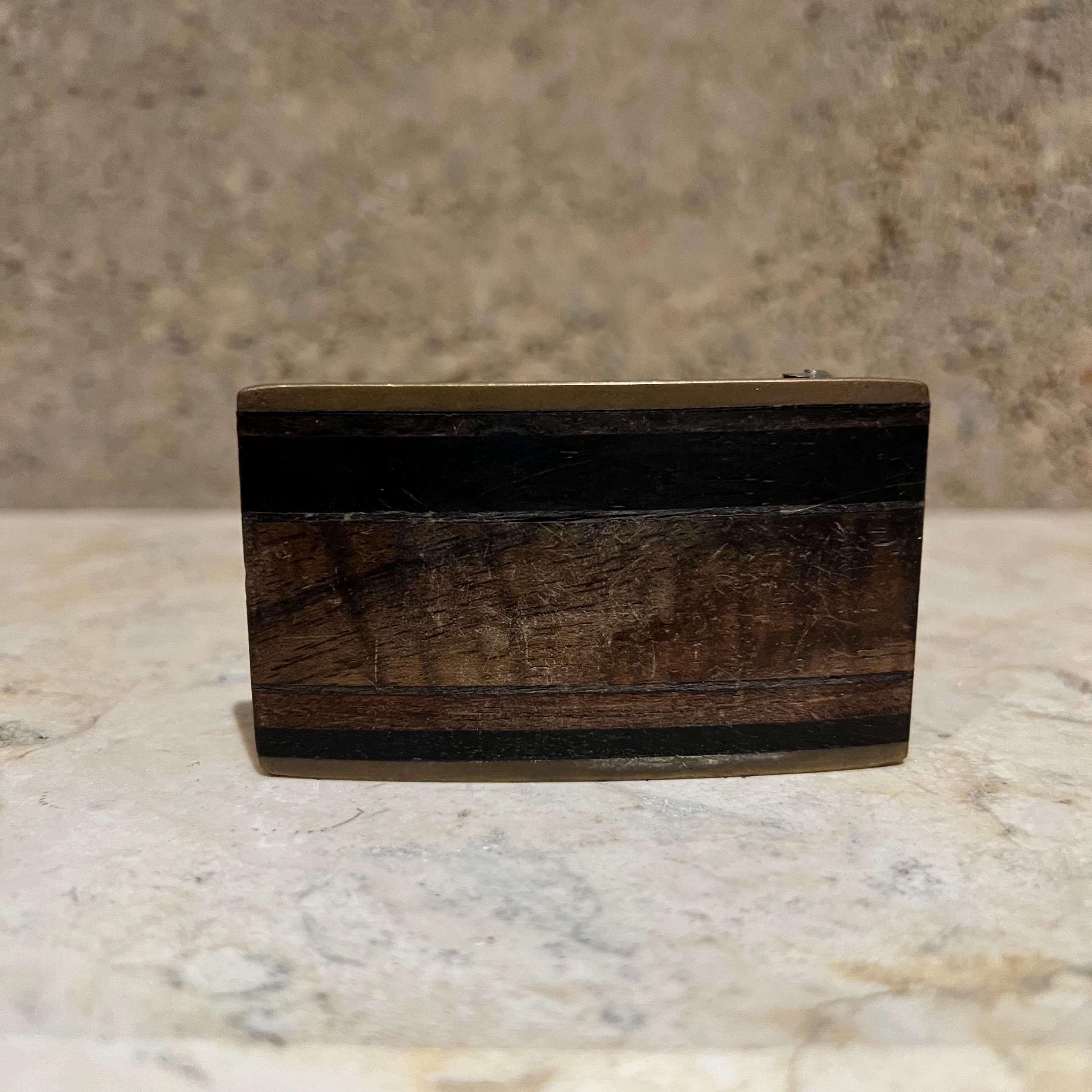 
1970s Brass Wood Belt Buckle Kenneth Reid New Mexico
3 w x 1.75 d x .5 d
Preowned vintage
Refer to images