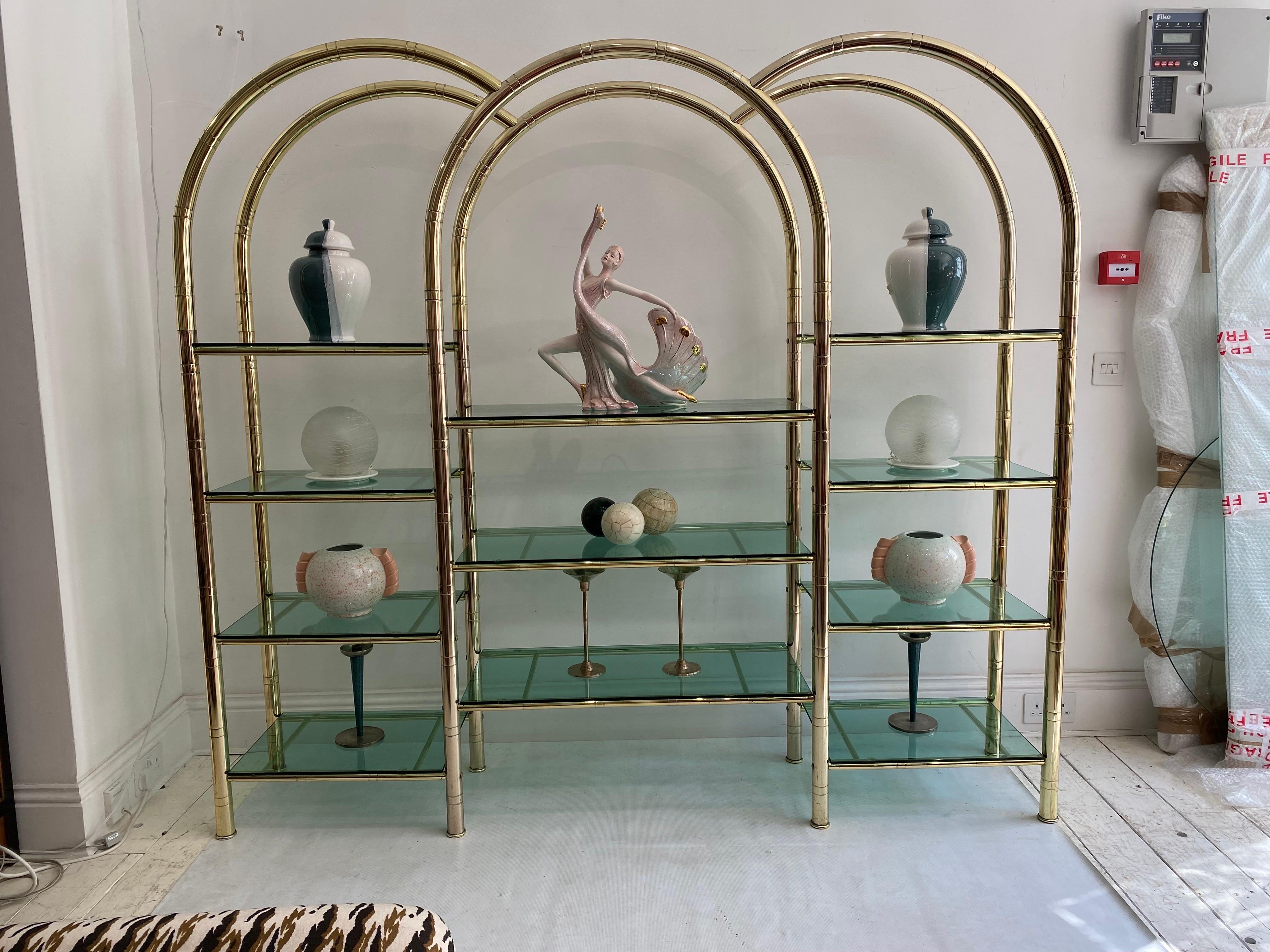An amazing late 1970s early 1980s Italian display unit etagere in brass plated faux bamboo and the most beautiful aqua green glass! All glass shelves are original with its characteristic vintage edge glass finish in a unique and large arched shape,