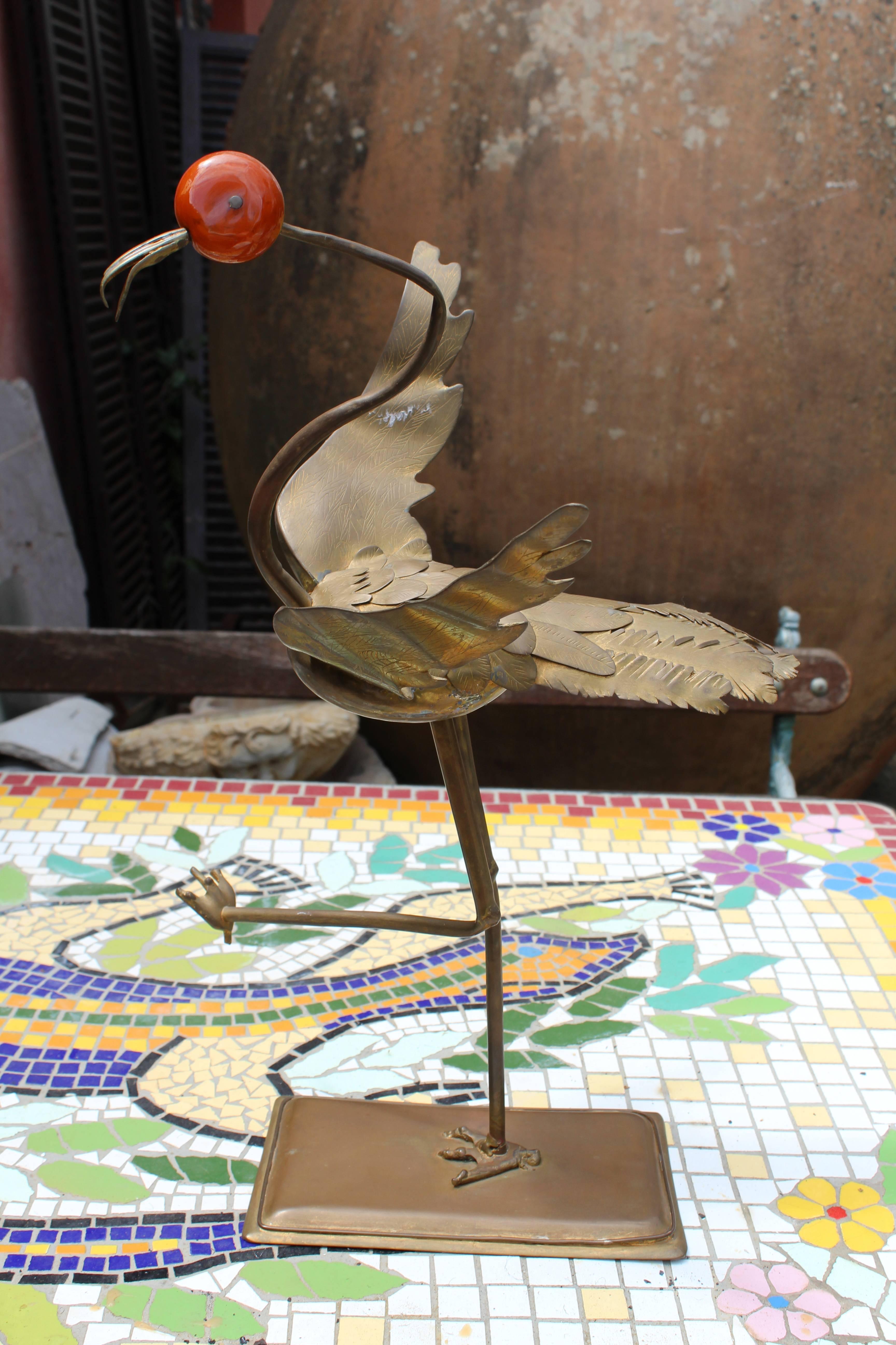 Peculiar one leg standing brass heron with red jade head.