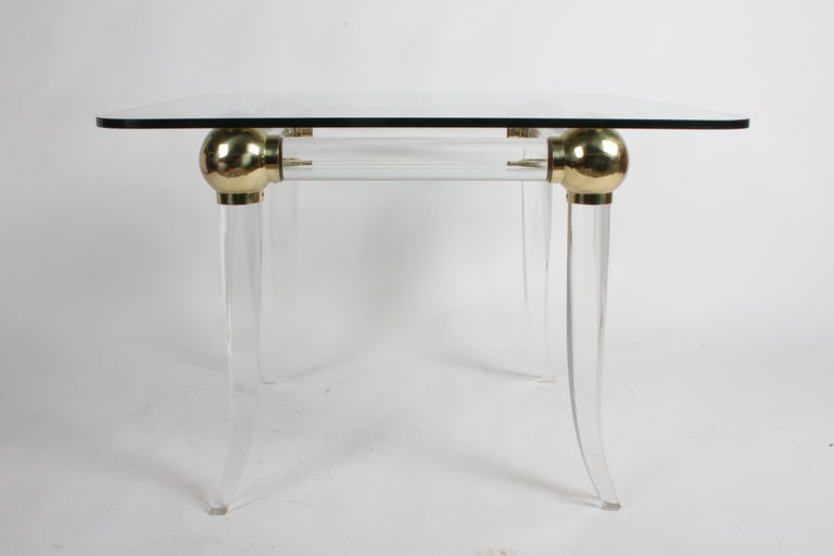 Hollywood Regency 1970s Brass and Lucite Game Table with Glass Top, Four Brass Balls on Saber Legs For Sale
