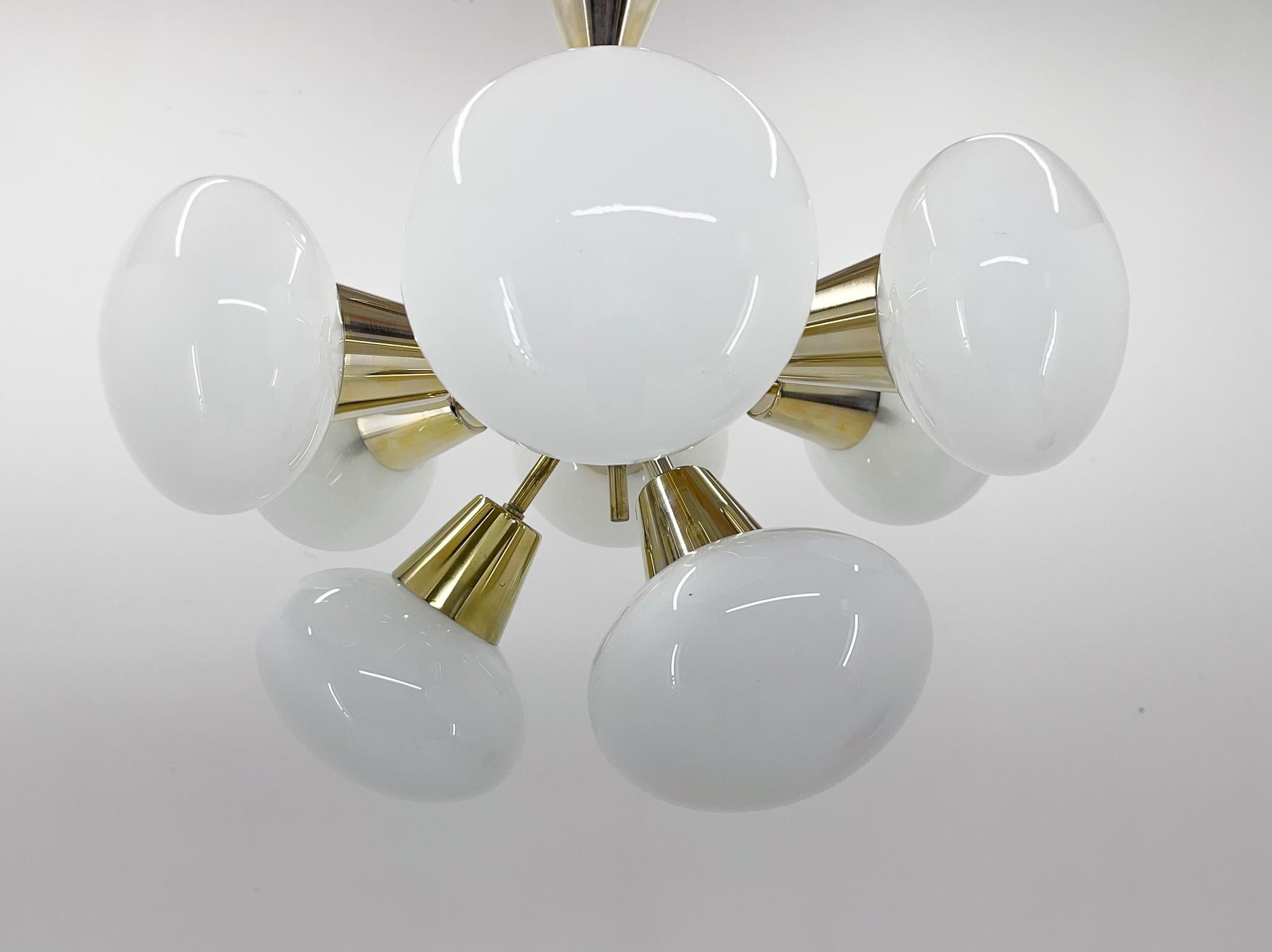 Vintage chandelier made of brass and opaline glass. Produced by the famous Kamenicky Senov in former Czechoslovakia in the 1970s. 
Bulbs: 9x 1 E14. US wiring compatible.