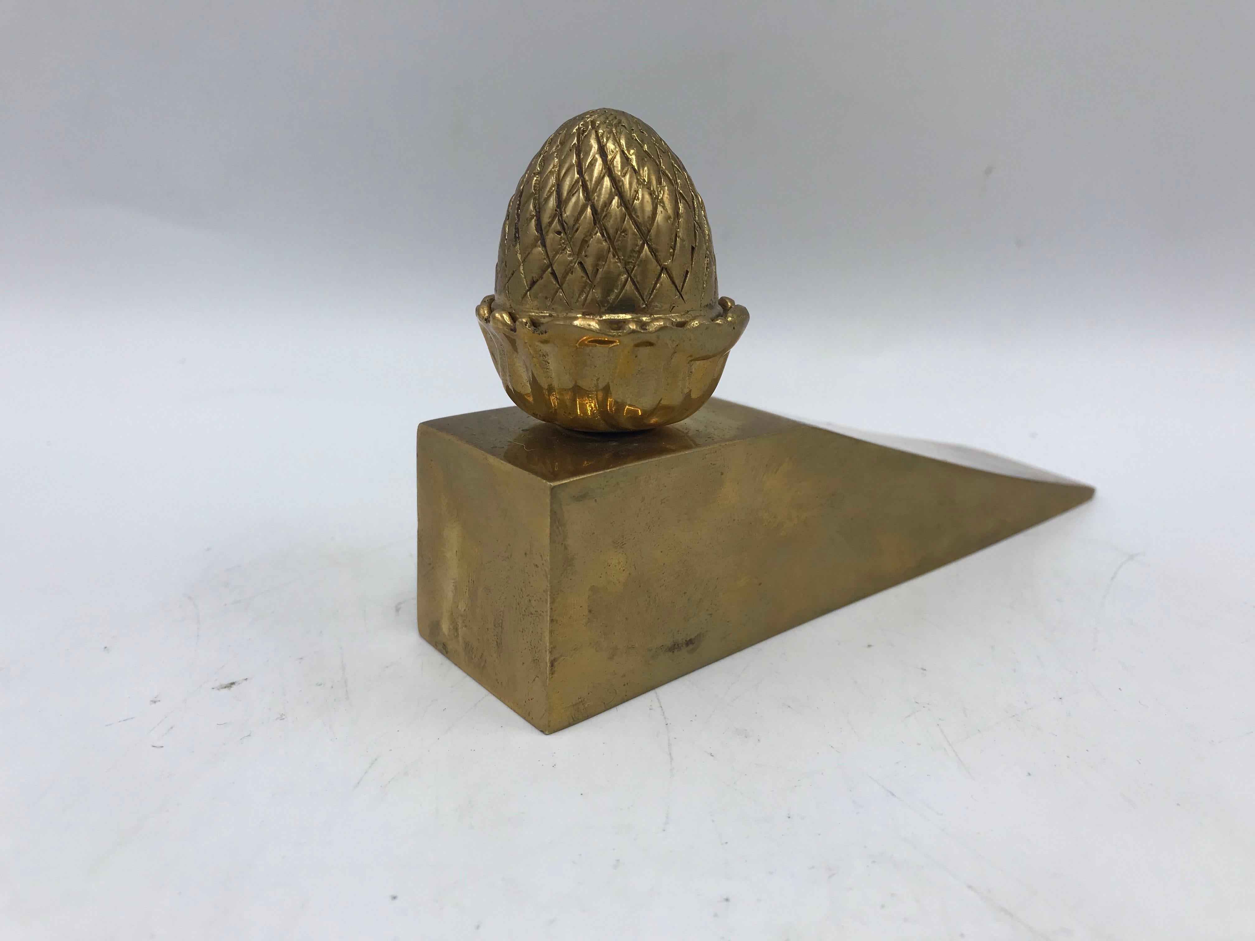 Offered is a beautiful, 1970s brass pineapple doorstop. This piece is perfect to hold open any door, welcoming guests!