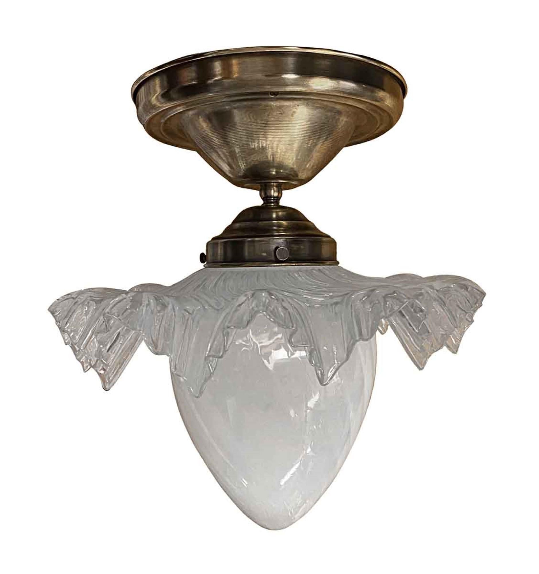 Brass semi flush mount light with a two-piece opalescent teardrop glass globe with ruffled edges. From a 1970s hotel. Please note, this item is located in our Scranton, PA location.