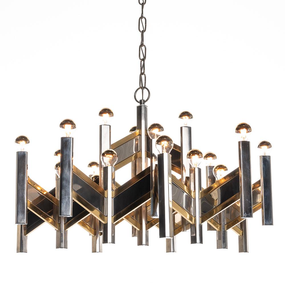 Classic Gaetano Sciolari style chandelier with characteristic use of chrome & brass. It holds twentyone light bulbs and it is the biggest one we have. It has an original 'sciolari' sticker on the canopy.

Please note, we have more chandeliers and