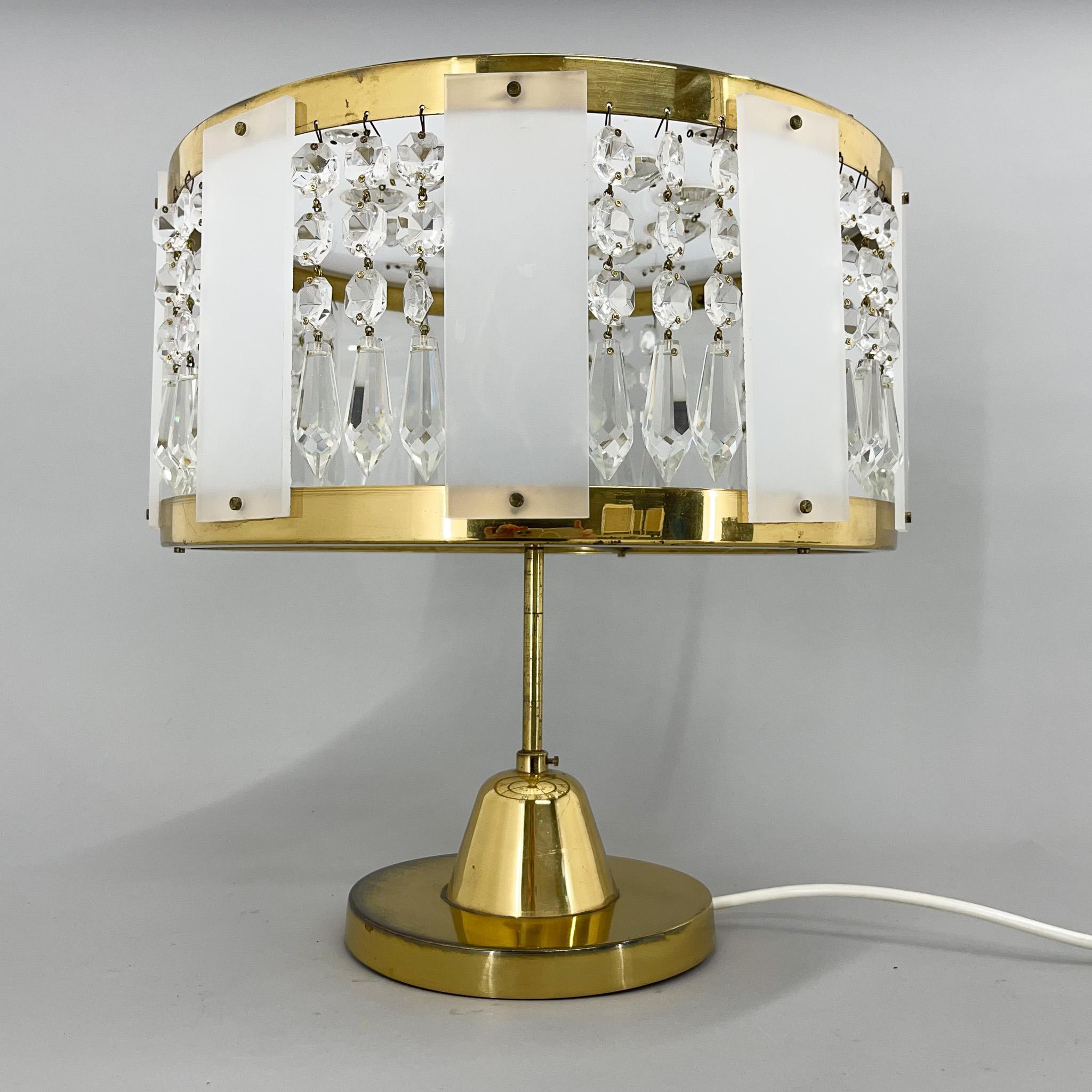 Unusual table lamp, produced in former Czechoslovakia by Novy Bydzov Glassworks, One crystal is missing at the top (see photo), but this does not affect the beauty of the light that the lamp casts. There are 2 pieces available.