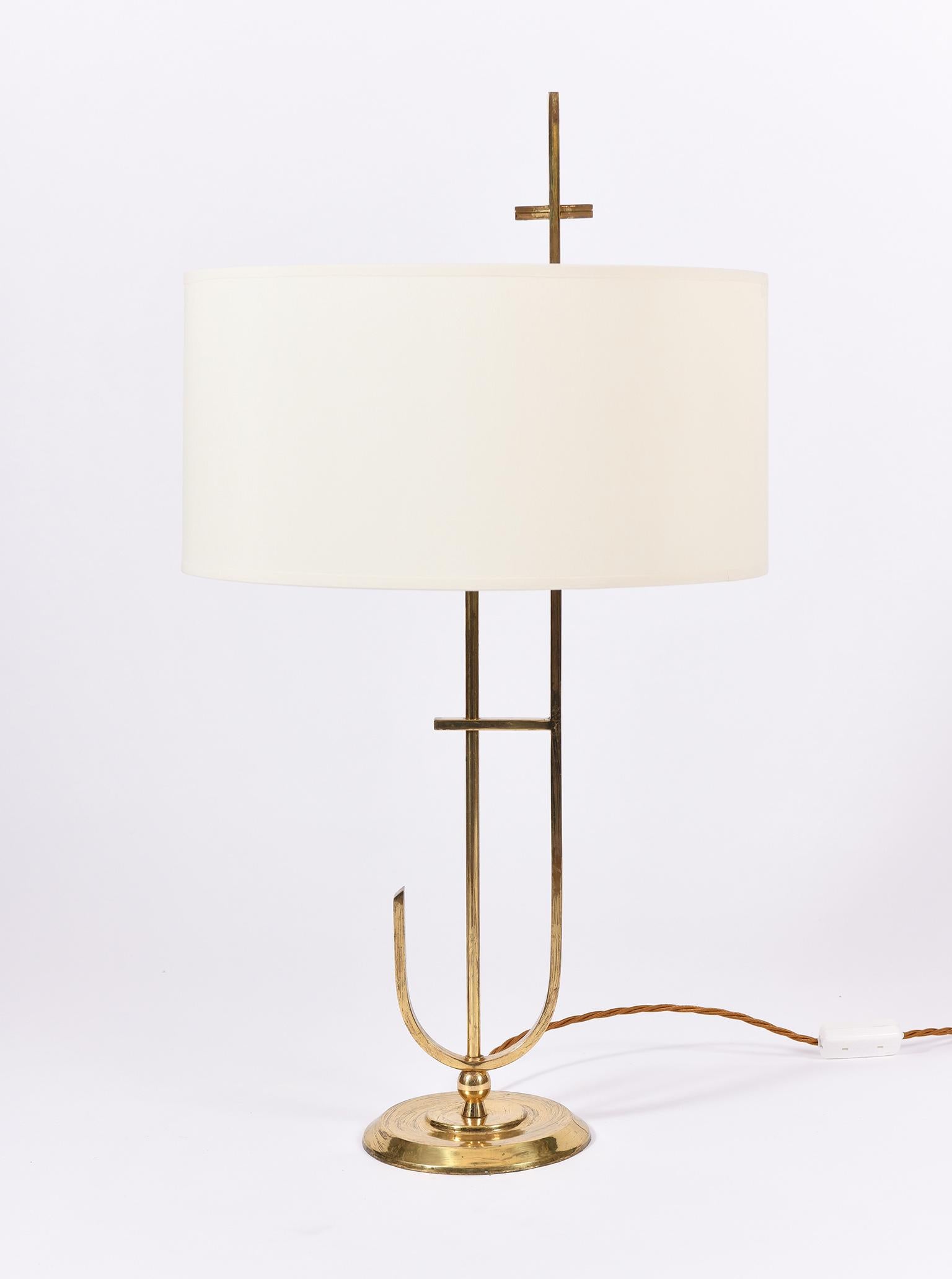 A brass table lamp, with a bespoke ivory fabric drum shade
France, circa 1970.