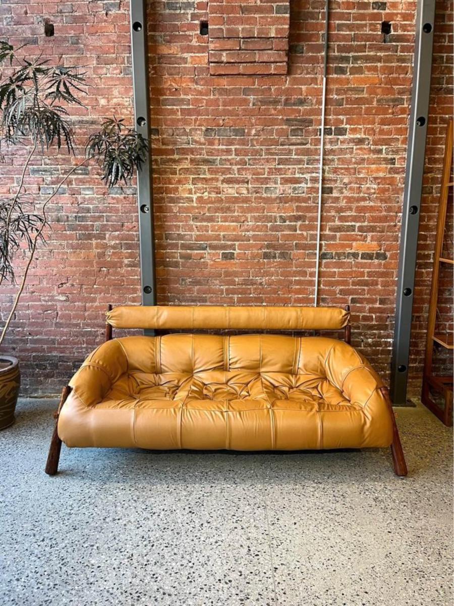 Introducing the iconic 1970's MP81 sofa by Percival Lafer, now rejuvenated in luxurious top grain leather. Crafted with a fiberglass base supported by sturdy Jatoba wood legs, this sofa offers both durability and style. Its injected foam seat,