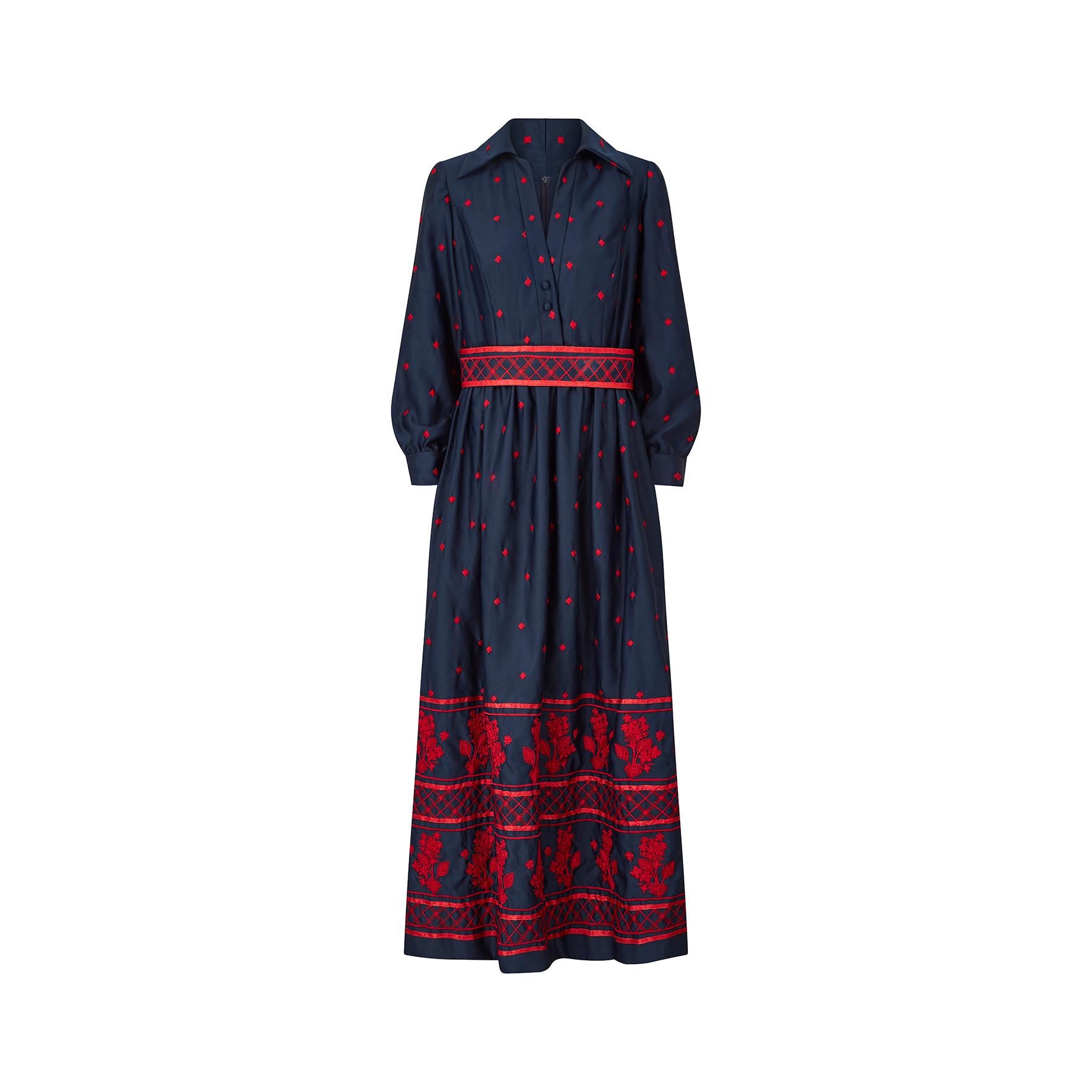 This is a really well made 1970s navy embroidered maxi dress by Brenner Couture. It's a smart shirt-waister style with a crossover V neck with two button fastenings and a pointed collar. The sleeves are gathered slightly at the cuff and are also