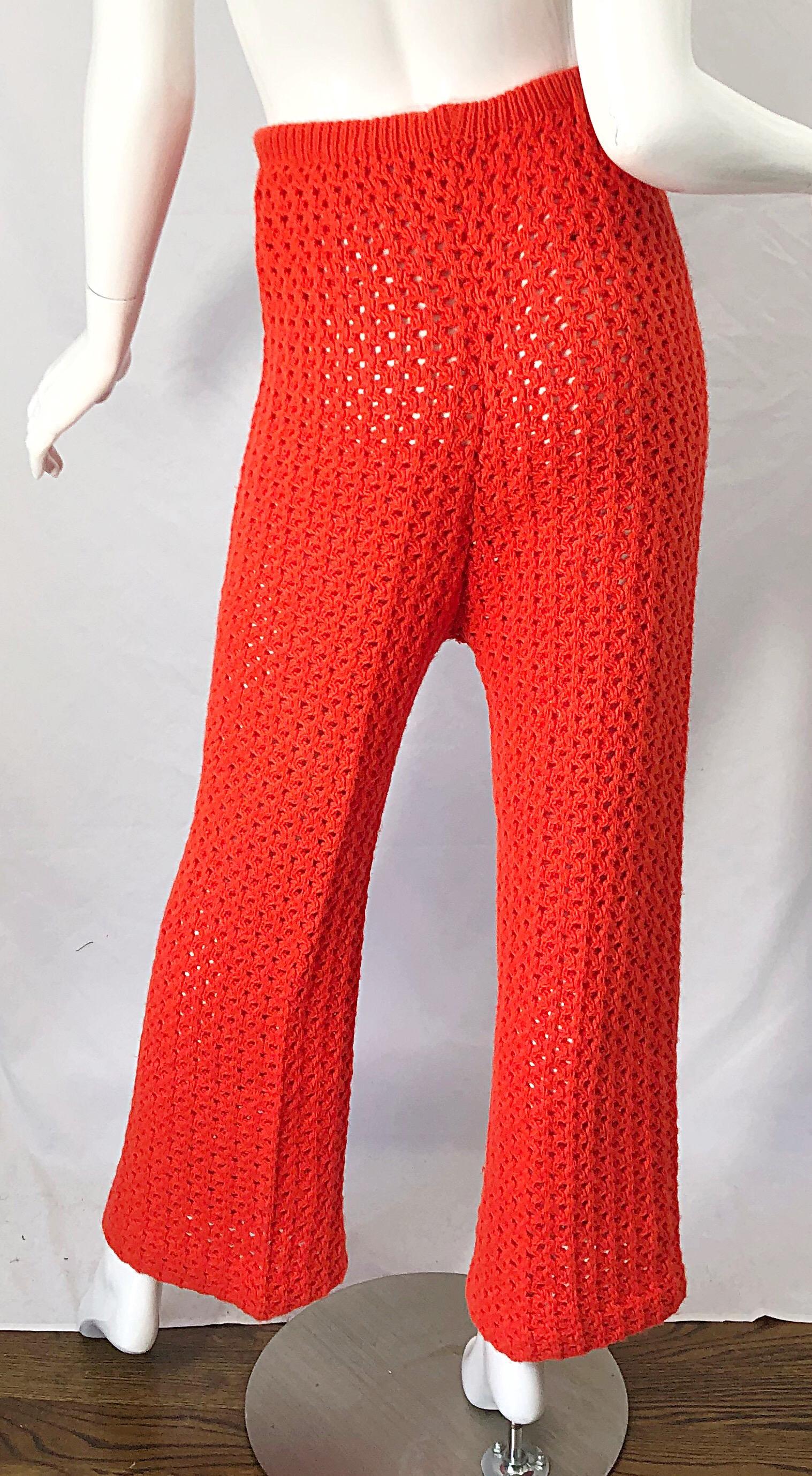Awesome vintage 70s bright coral orange fully crochet high waisted flared leg trousers ! Crochet work was completely constructed by hand. Elastic waistband makes these pants easy to wear by many sizes. Can easily be dressed up or down. Great with a