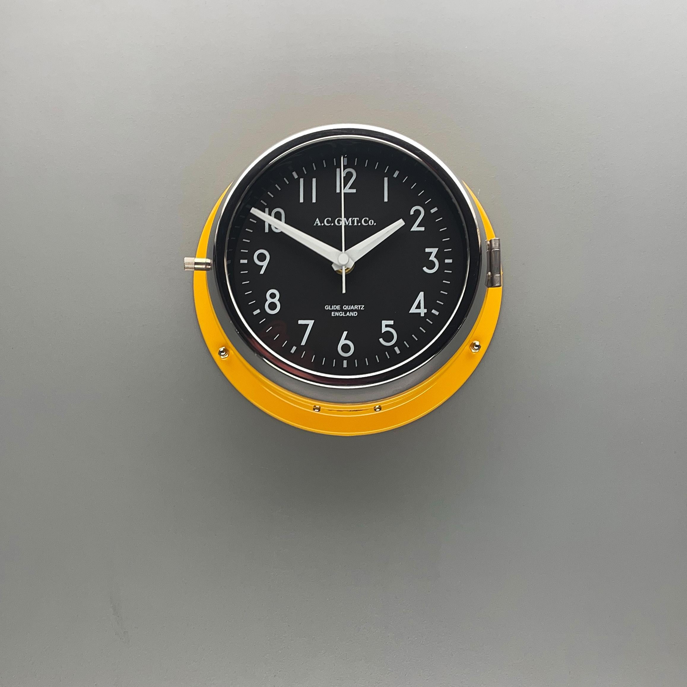 Late 20th Century 1970s British Yellow Illumination AC GMT Co. Classic Quartz Wall Clock For Sale