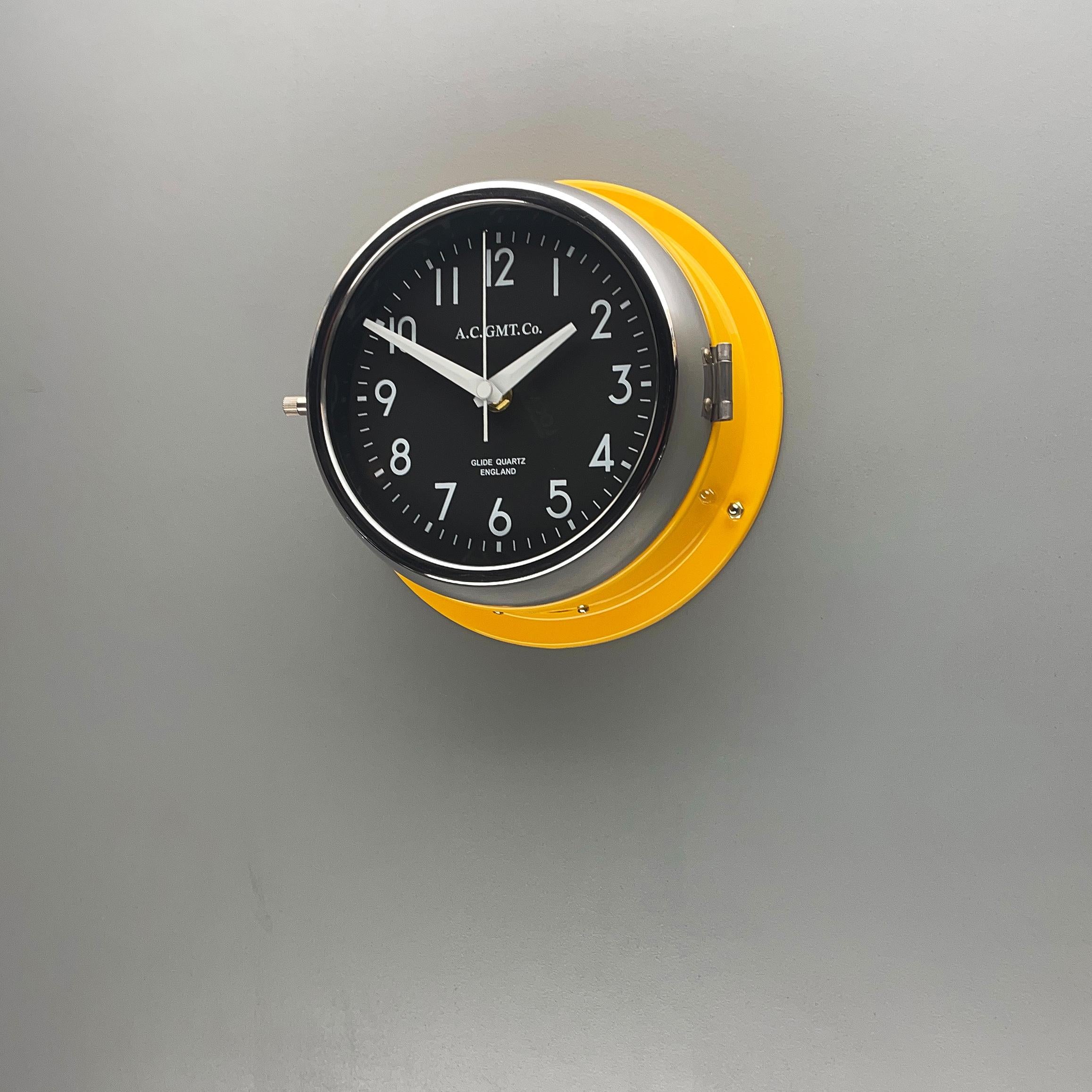 Steel 1970s British Yellow Illumination AC GMT Co. Classic Quartz Wall Clock For Sale