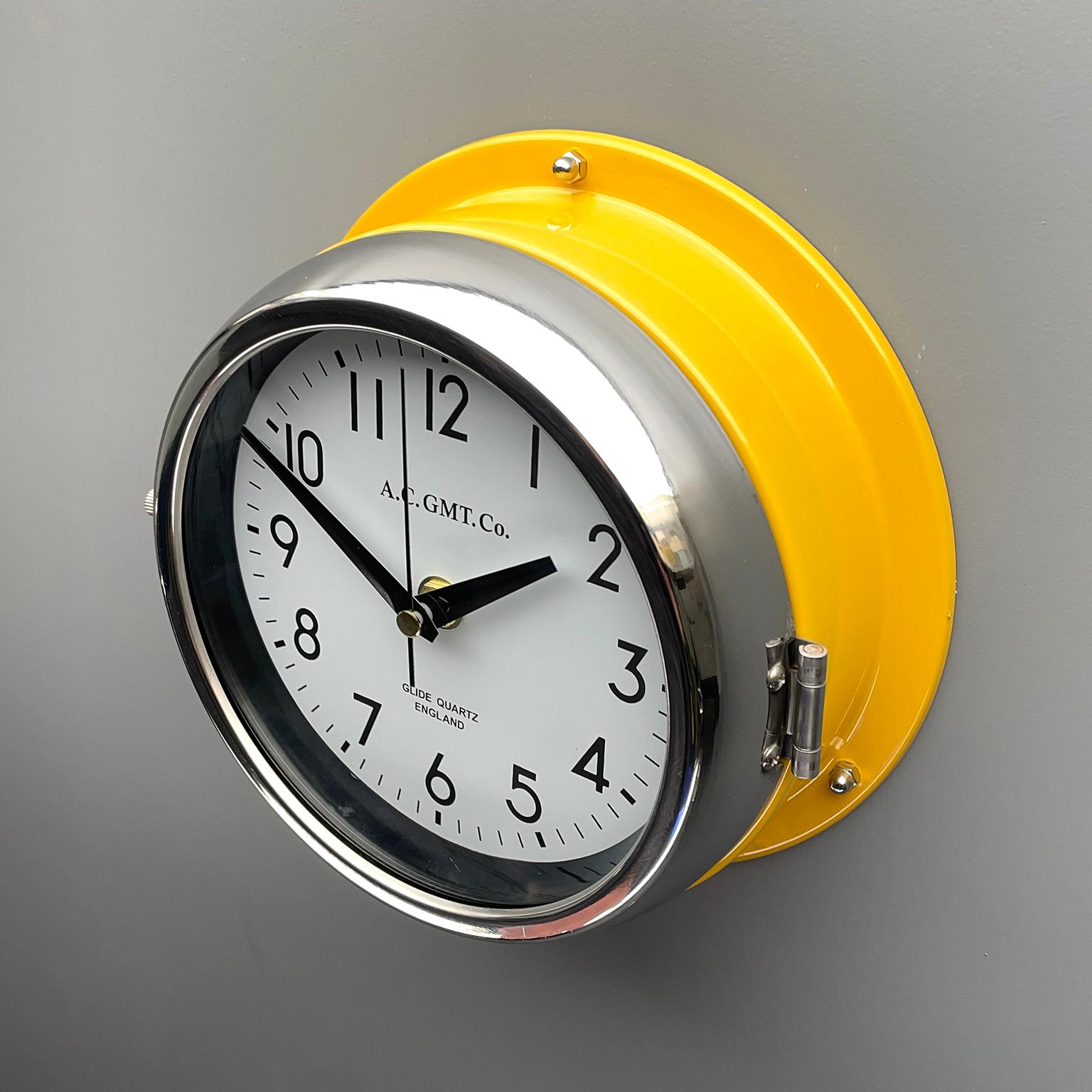 Late 20th Century 1970's British Yellow Illumination & White AC GMT Co. Classic Quartz Wall Clock For Sale