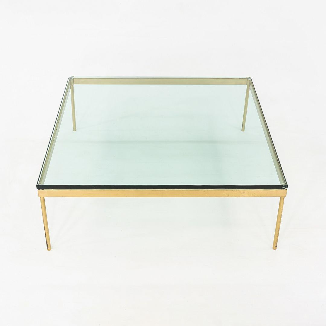 This is a Minimalist Square Coffee Table, attributed to Ward Bennett for Brickel Associates, c.1970s, USA. The table is large and low, composed of a polished bronze frame, and has a thick glass top. The lean metal base gives the piece a clean,