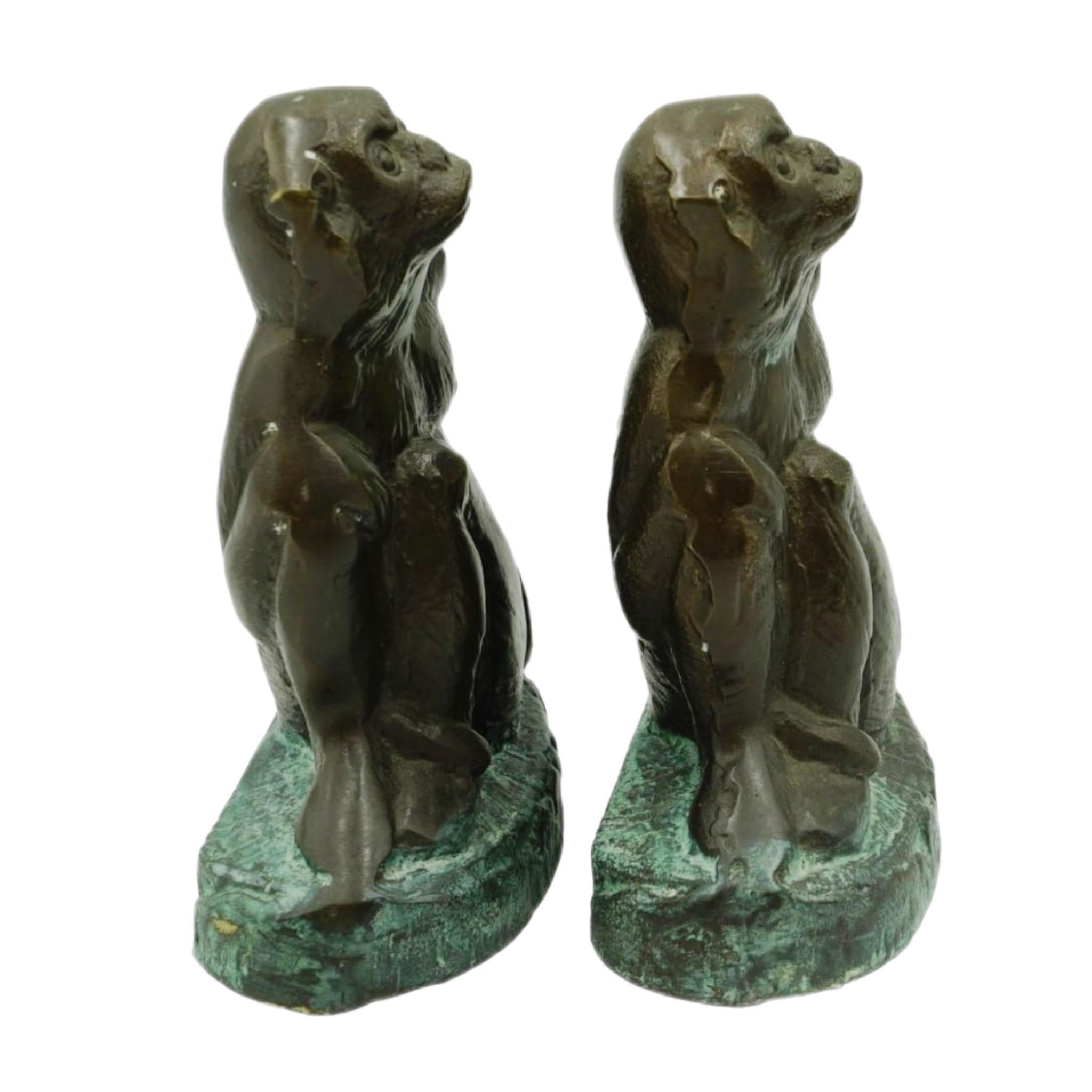 This is a pair of bronze brass heavy metal monkey bookends. The finish is an antiqued bronze patina with verdigris style accent. Each monkey measures 6 inches tall by 4.5 inches across and are 2.5 inches deep. The pair is in excellent shape and