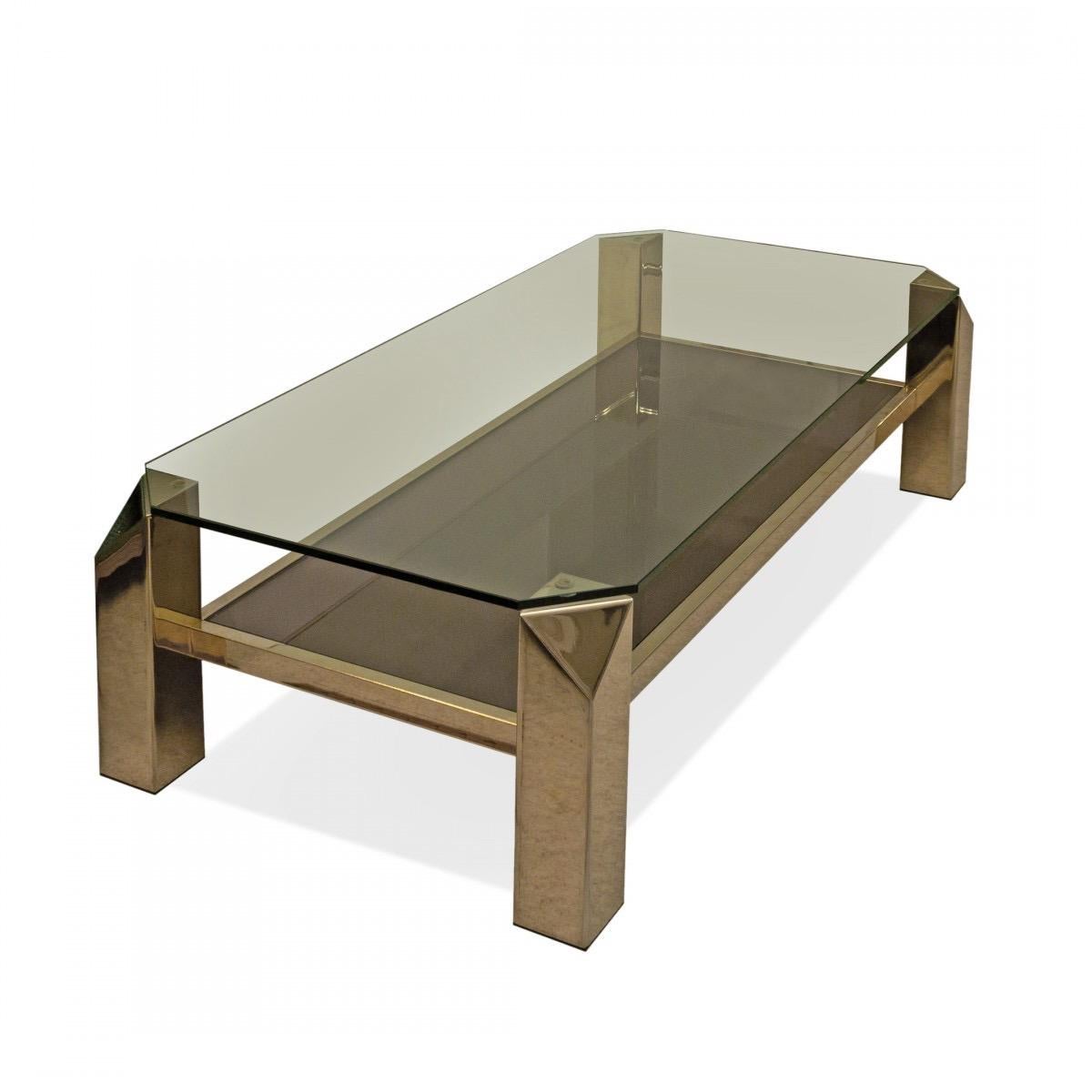 A vintage Karl Springer style rectangular coffee table in bronze-finish metal with two smoked glass shelves, USA, circa 1970.

Dimensions: 47.5