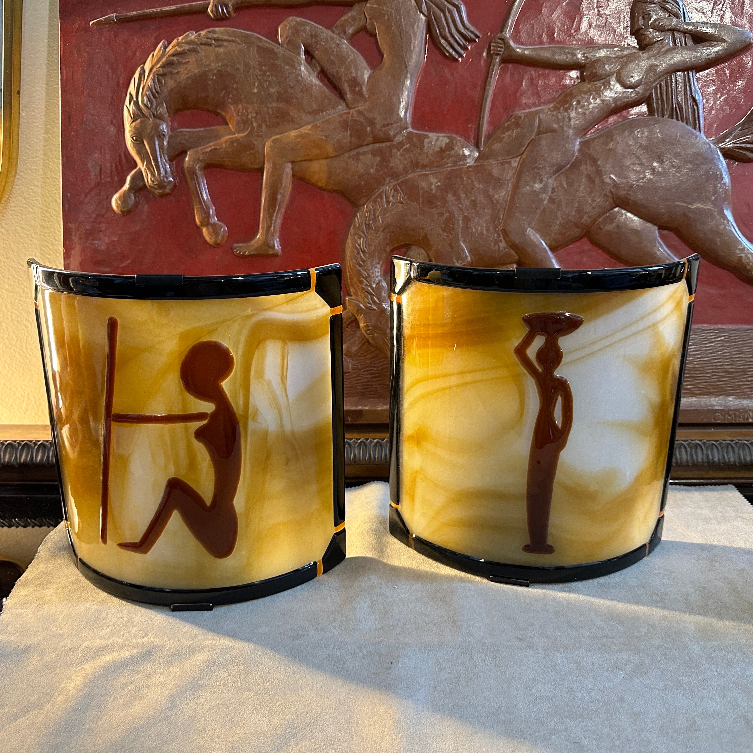 A pair of square wall sconces designed and manufactured in Italy in the Seventies, the semi curved brown and amber glass depicts two different figures of woman. They are in working order and in very good. condition overall, each one needs a regular