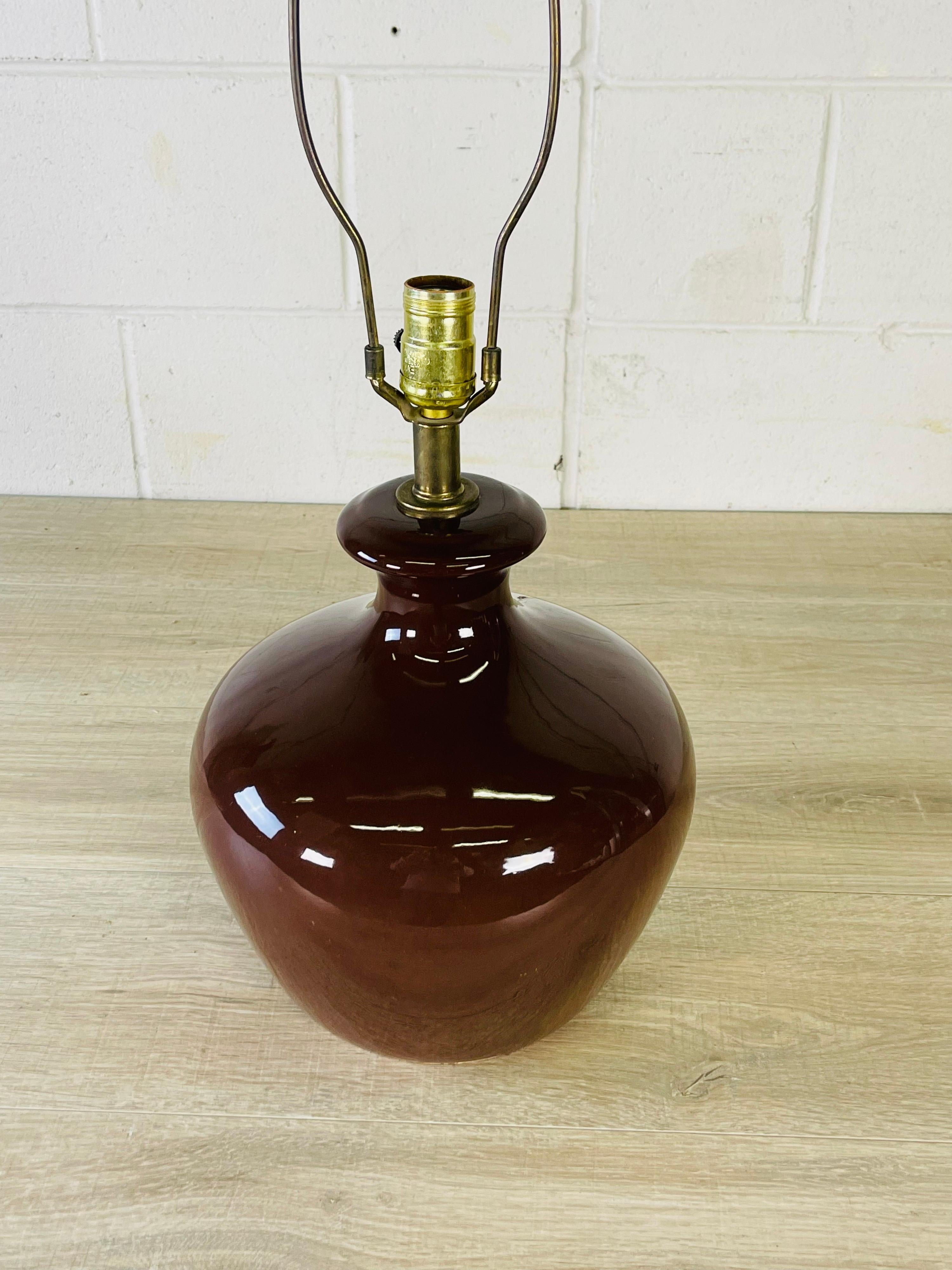 Vintage 1970s brown ceramic bulbous table lamp. Wired for the US and in working condition. Uses a standard 100 watt bulb. Socket, 16.5”H. Harp, 4” diameter x 9” height. No marks.