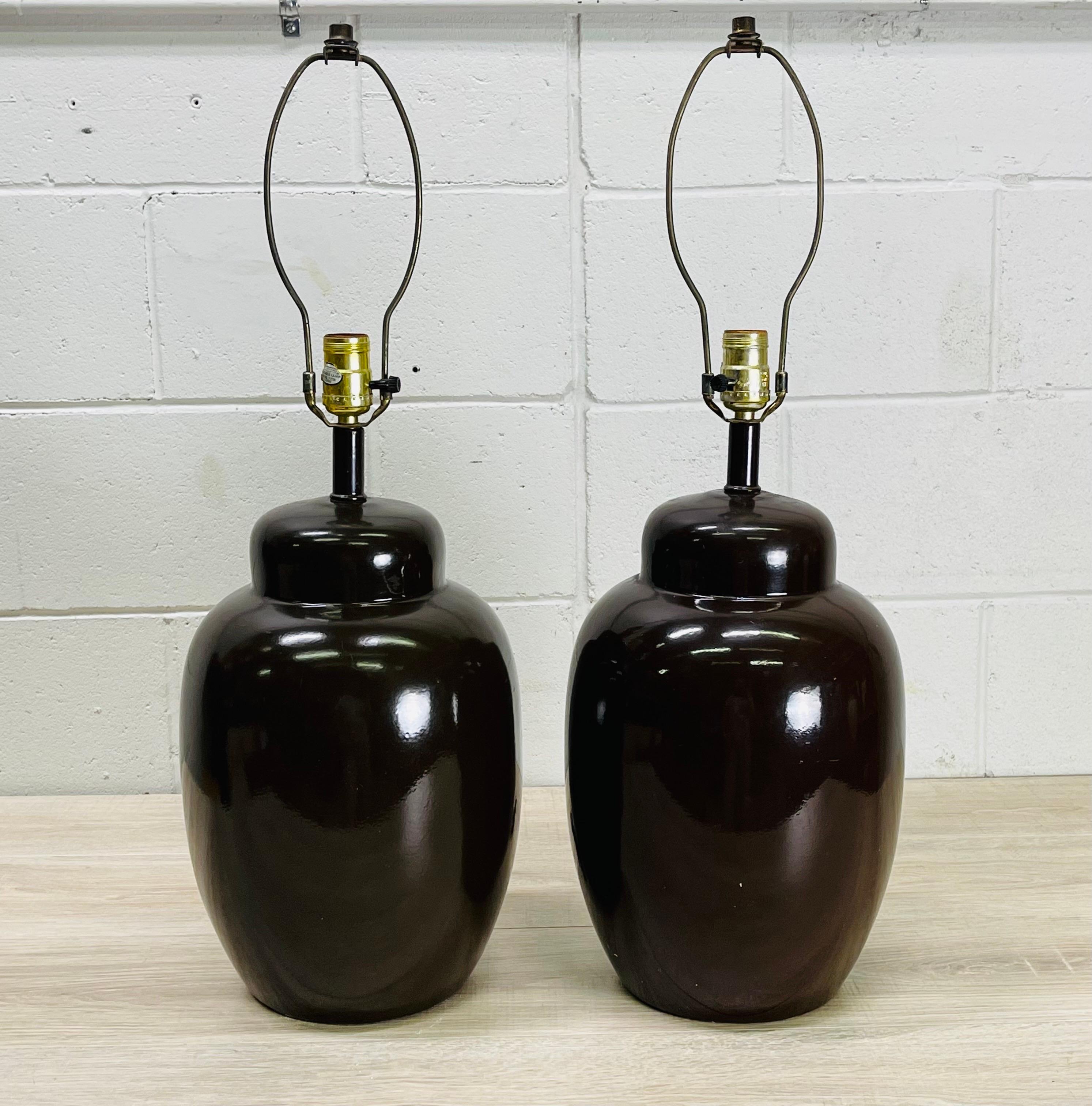 Vintage 1970s pair of brown ceramic table lamps. The lamps are wired for the US and in working condition. The lamps use a standard 100W bulb. Socket, 19” H. Harp, 4”Diameter x 8” height. No marks