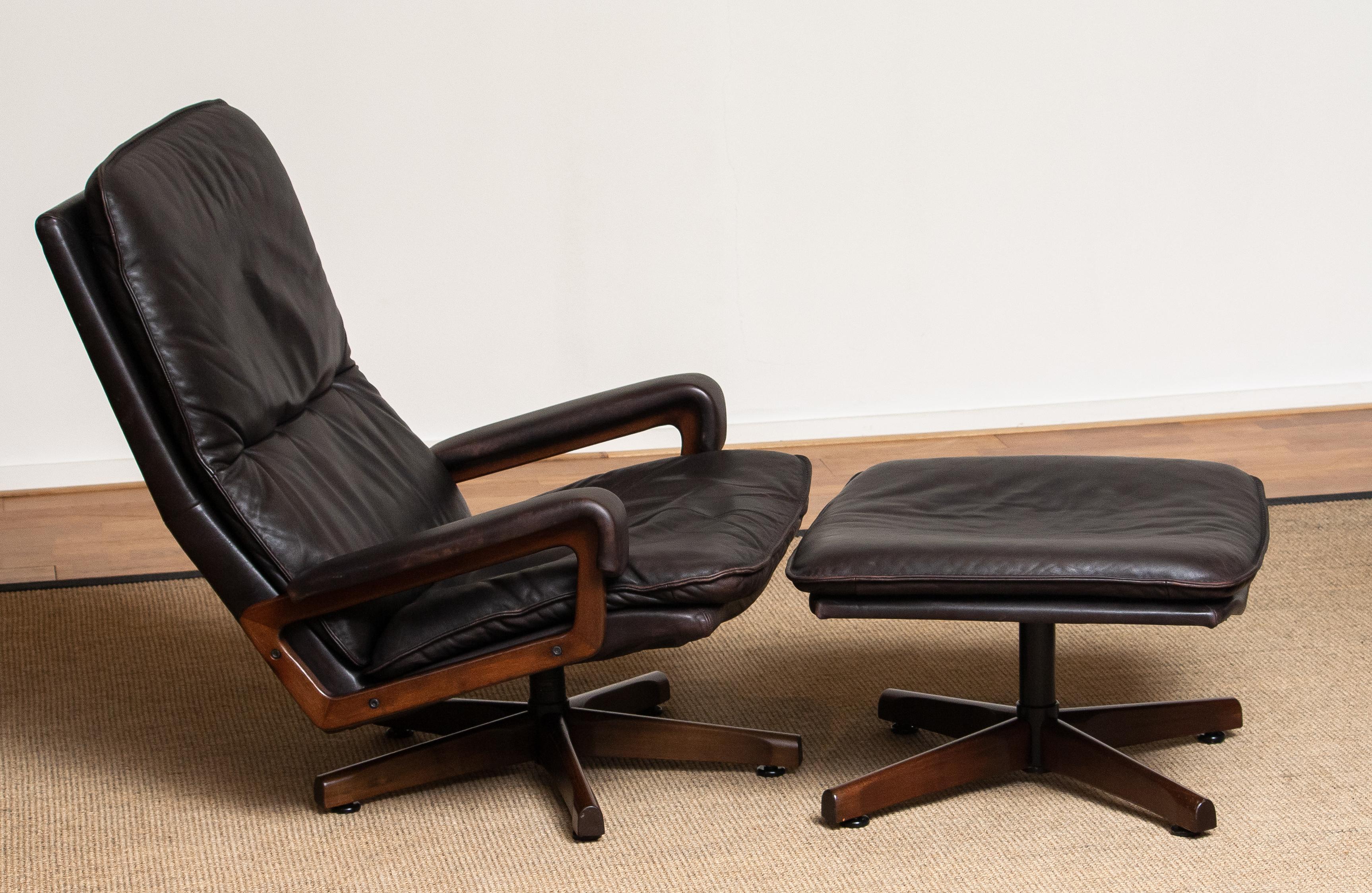 Very comfortable set of dark brown leather swivel chair and matching ottoman designed by André Vandenbeuck for WK Mobler in Germany known by model name 