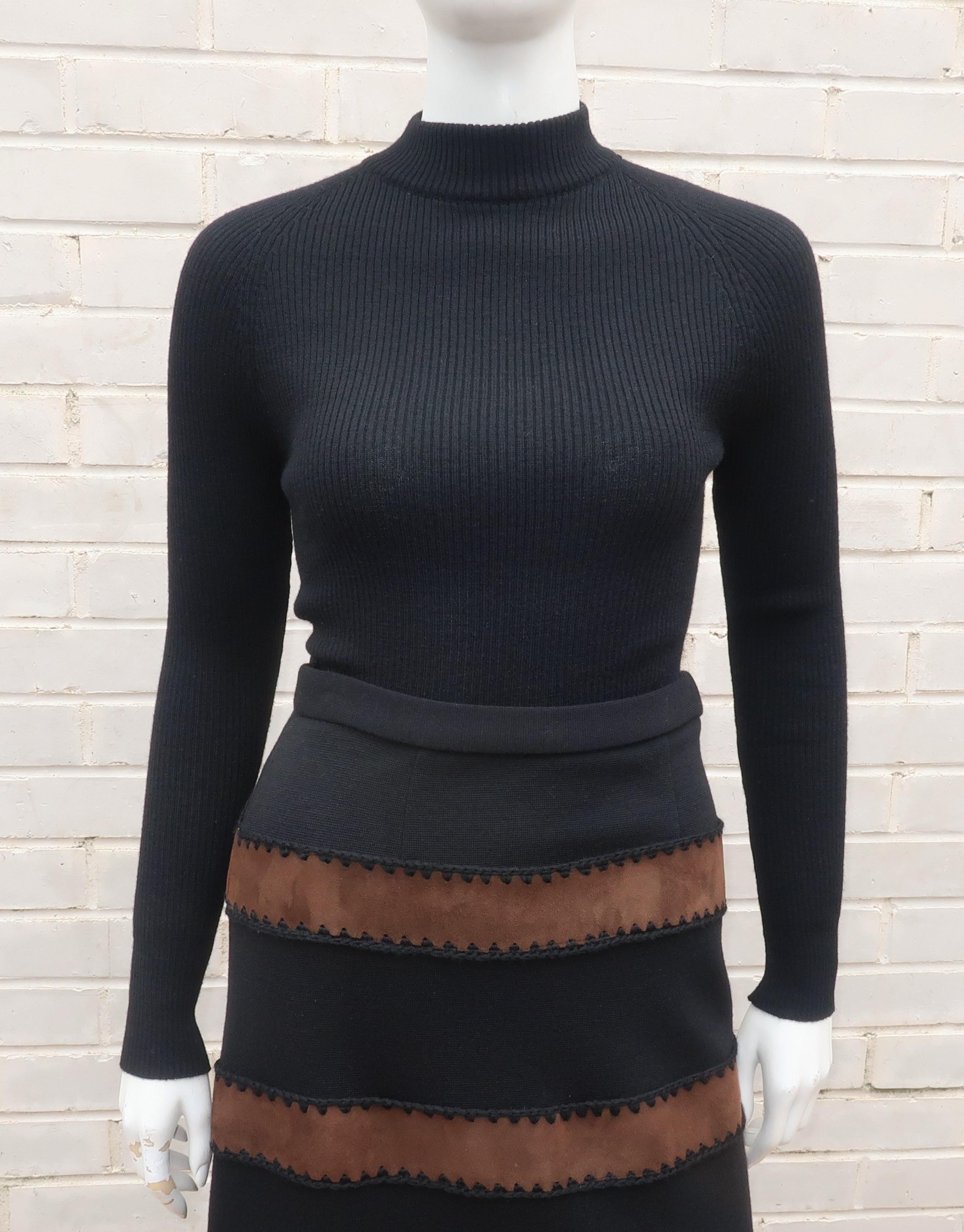 A two piece wool knit ensemble consisting of a skinny ribbed turtleneck top and a maxi skirt embellished with brown suede bands.  The sweater zips at the back and the skirt zips and hooks at the side.  The crochet style stitching at the suede gives