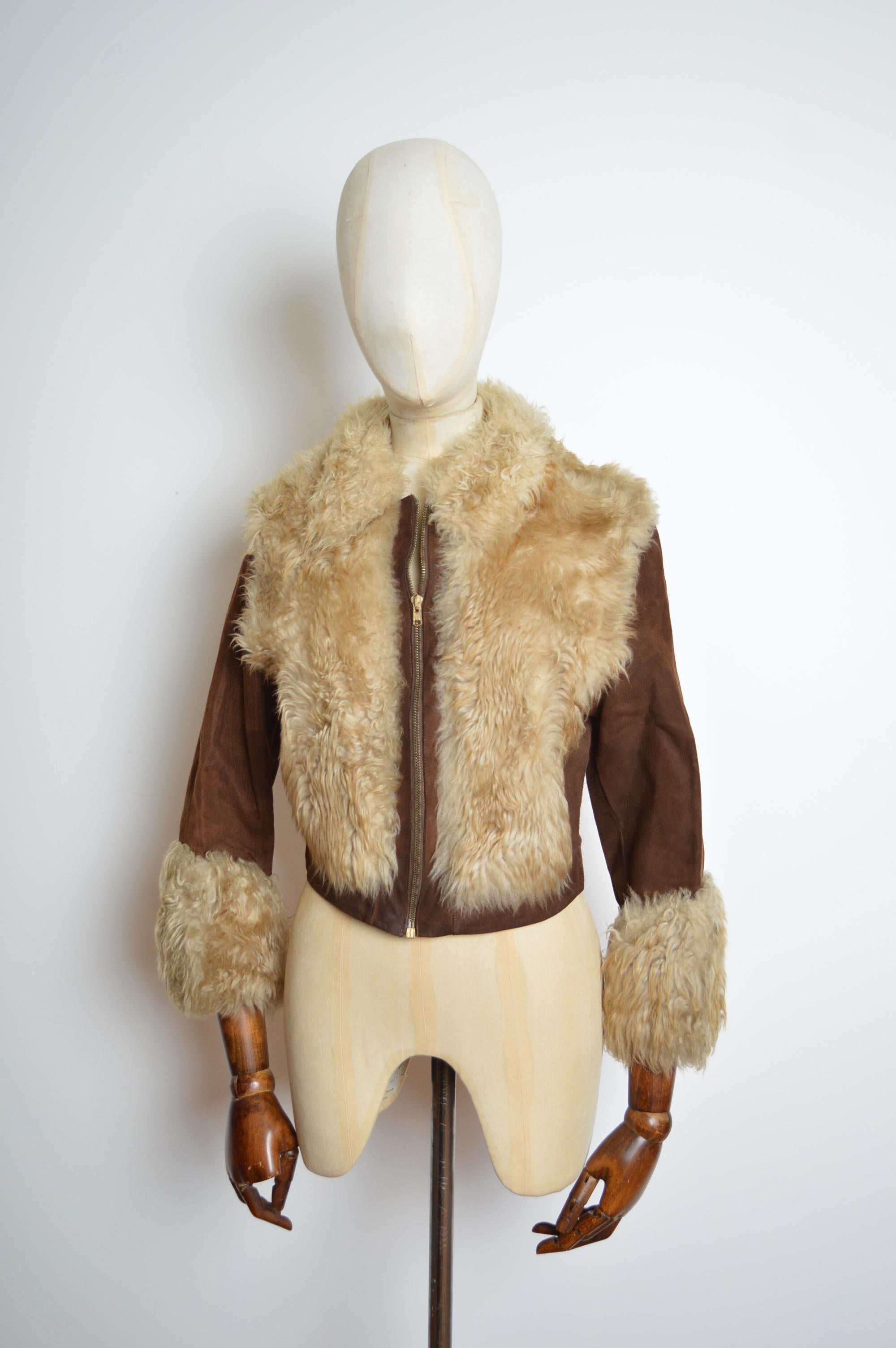 Fun 1970's Jacket constructed of Shearling and suede Panels featuring a fluffy body, wrist cuffs and central zip down the front closure. 
Size; U.K. 6-10 / Small-Medium 
Pit to Pit; 18”
Nape to Hem; 21”
Waist; Upto 30”
Condition; 7/10 Overall good