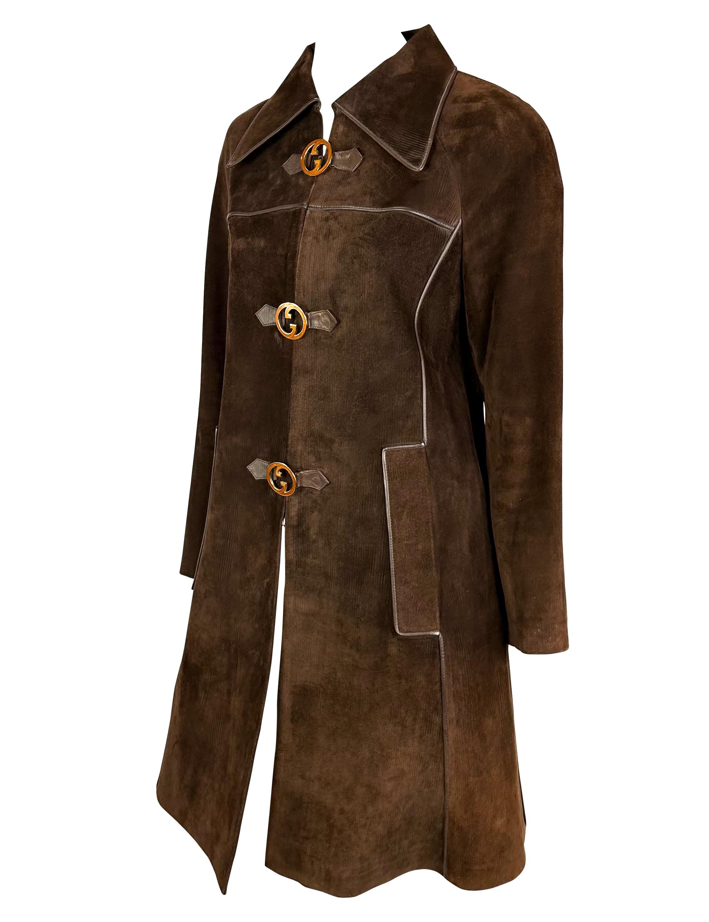 Presenting an absolutely incredible brown suede striped Gucci trench coat. From the 1970s, this ultra-rare coat is constructed entirely of patterned brown suede. The coat features leather piping, a large collar, and is made complete with large