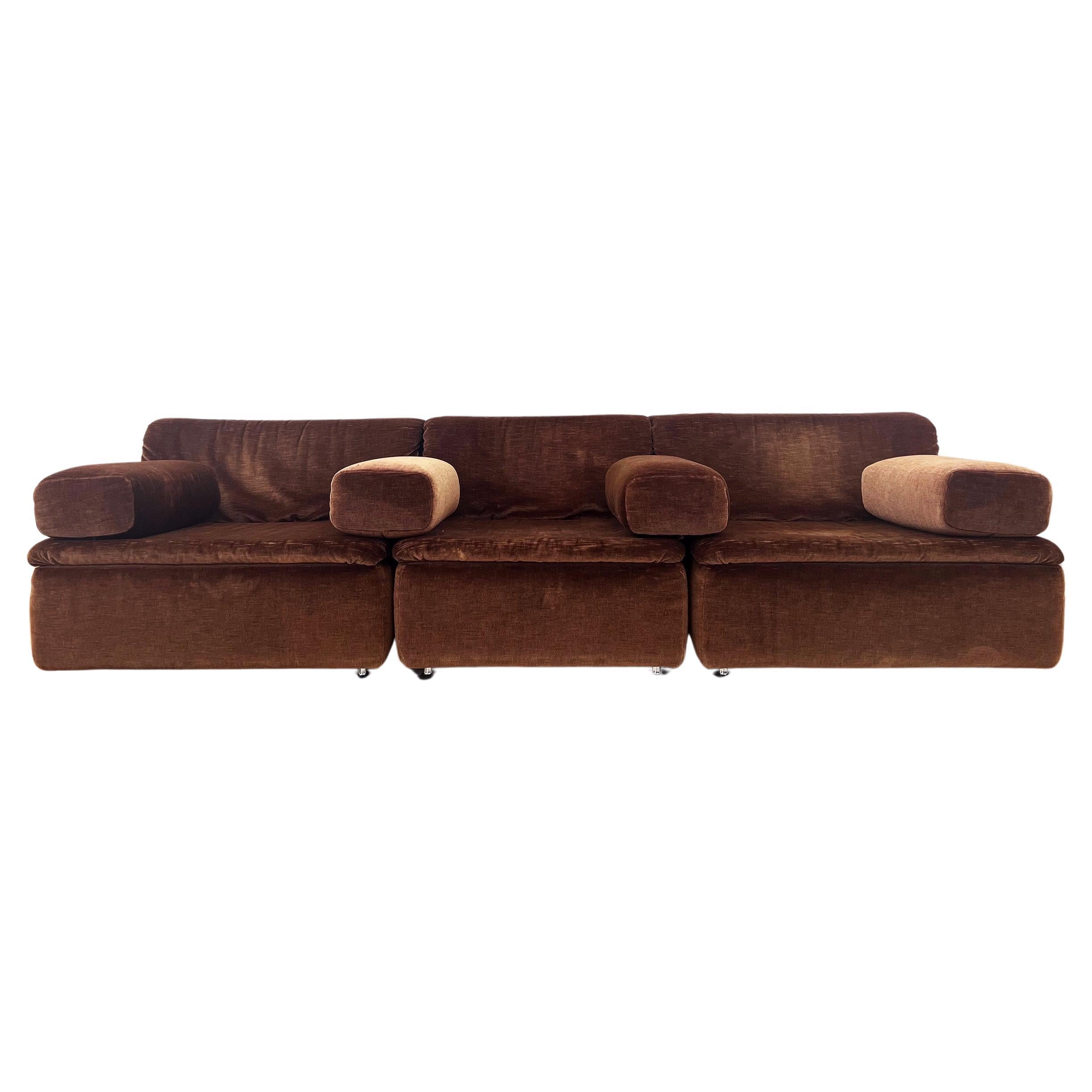 Very cool three piece modular Sofa sectional which can also be used as three separate lounge chairs. Feature 4 very cool metal feet on the bottom of each piece. Attributed to Mario Bellini. Iconic style. Upholstered in brown velour, which feels like