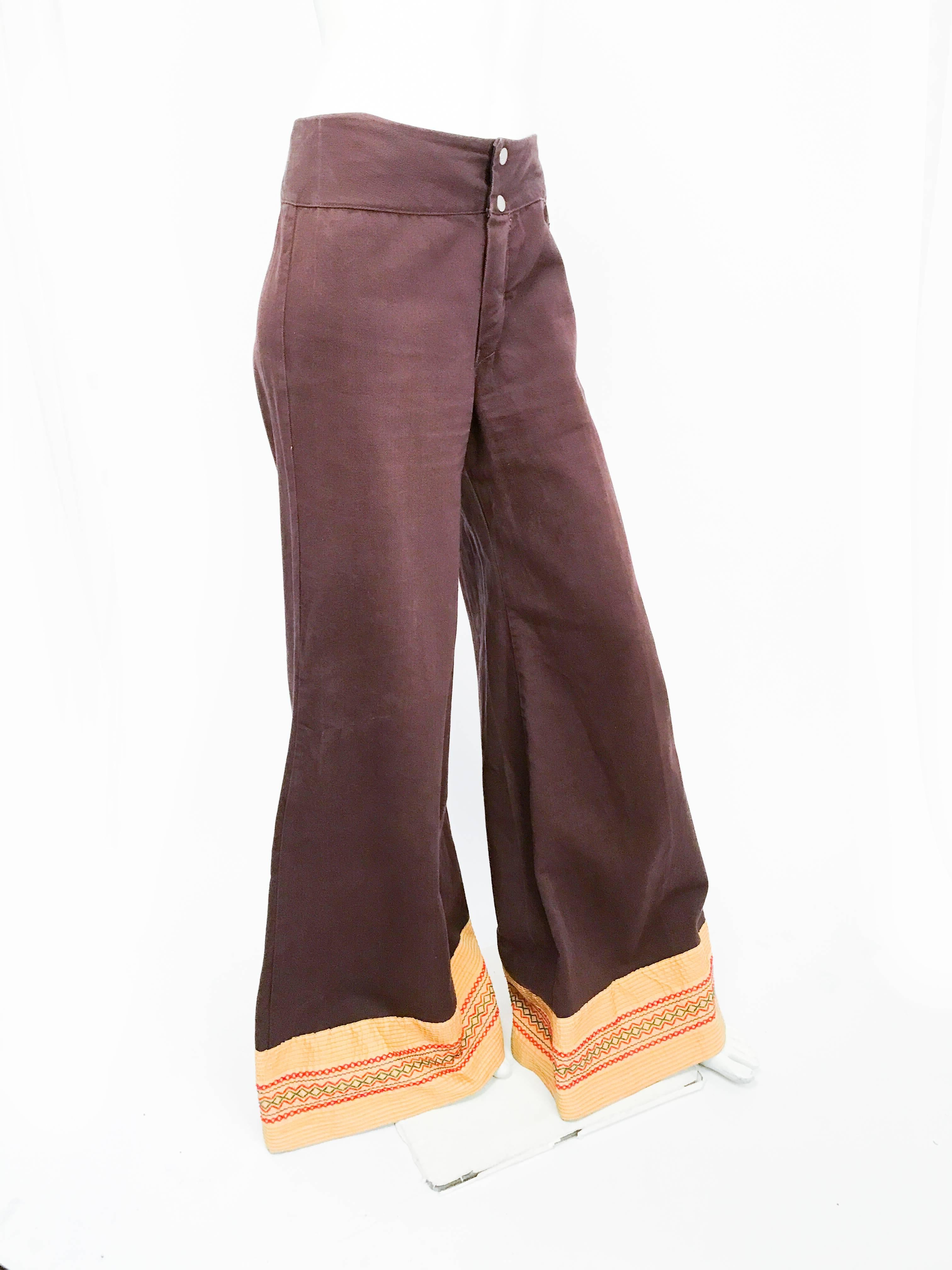 1970s Brown Wide-legged Pants with Embellished Hem. Brown wide-legged pants with embroidered yellow/green/red hems.  Zipper fly and snap reinforcement.