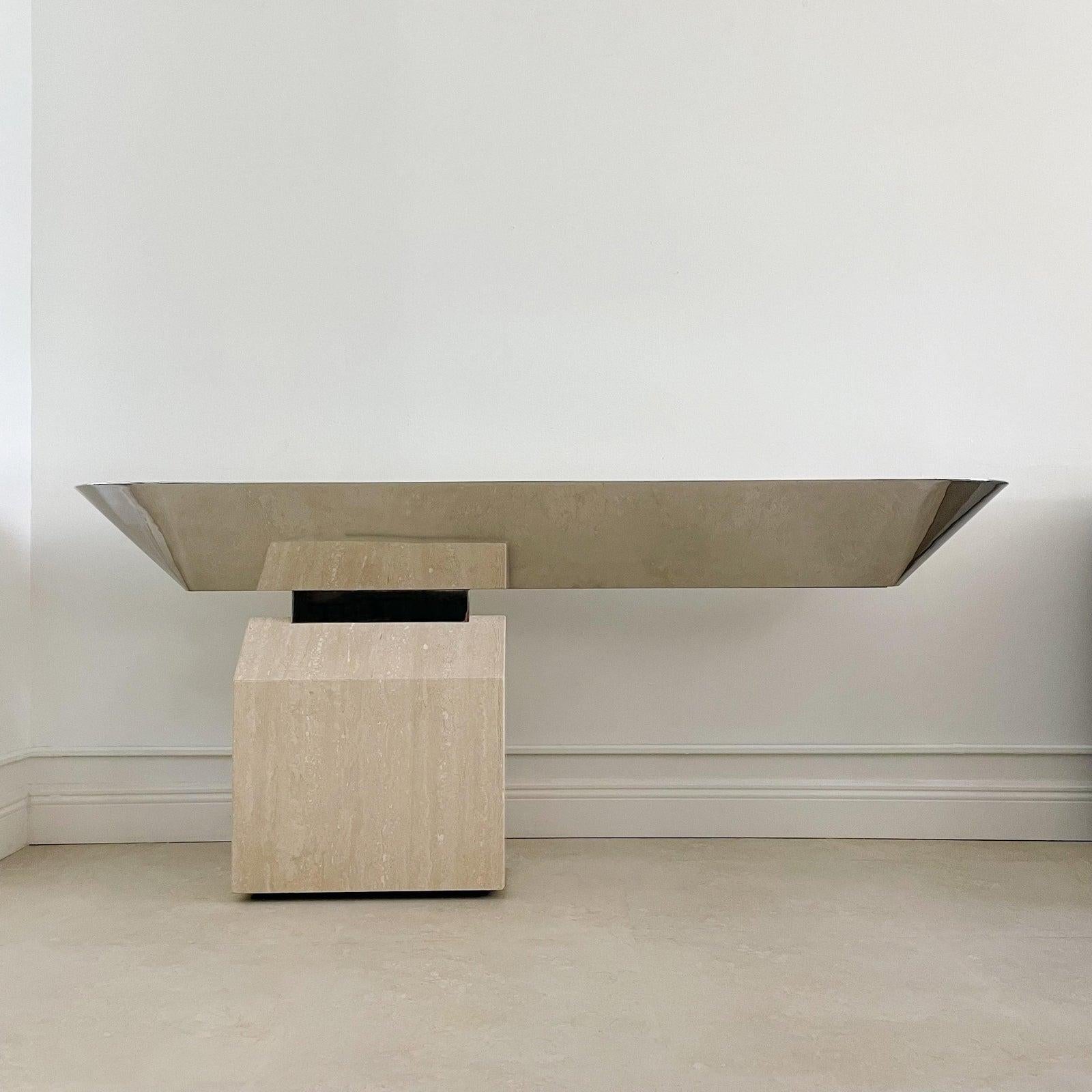 Circa 1970's, the outstanding cantilevered design of the Offbeam illuminated console adds drama to any space. The polished stainless steel trough and polished stainless steel connector are supported by the precisely fabricated gabled travertine