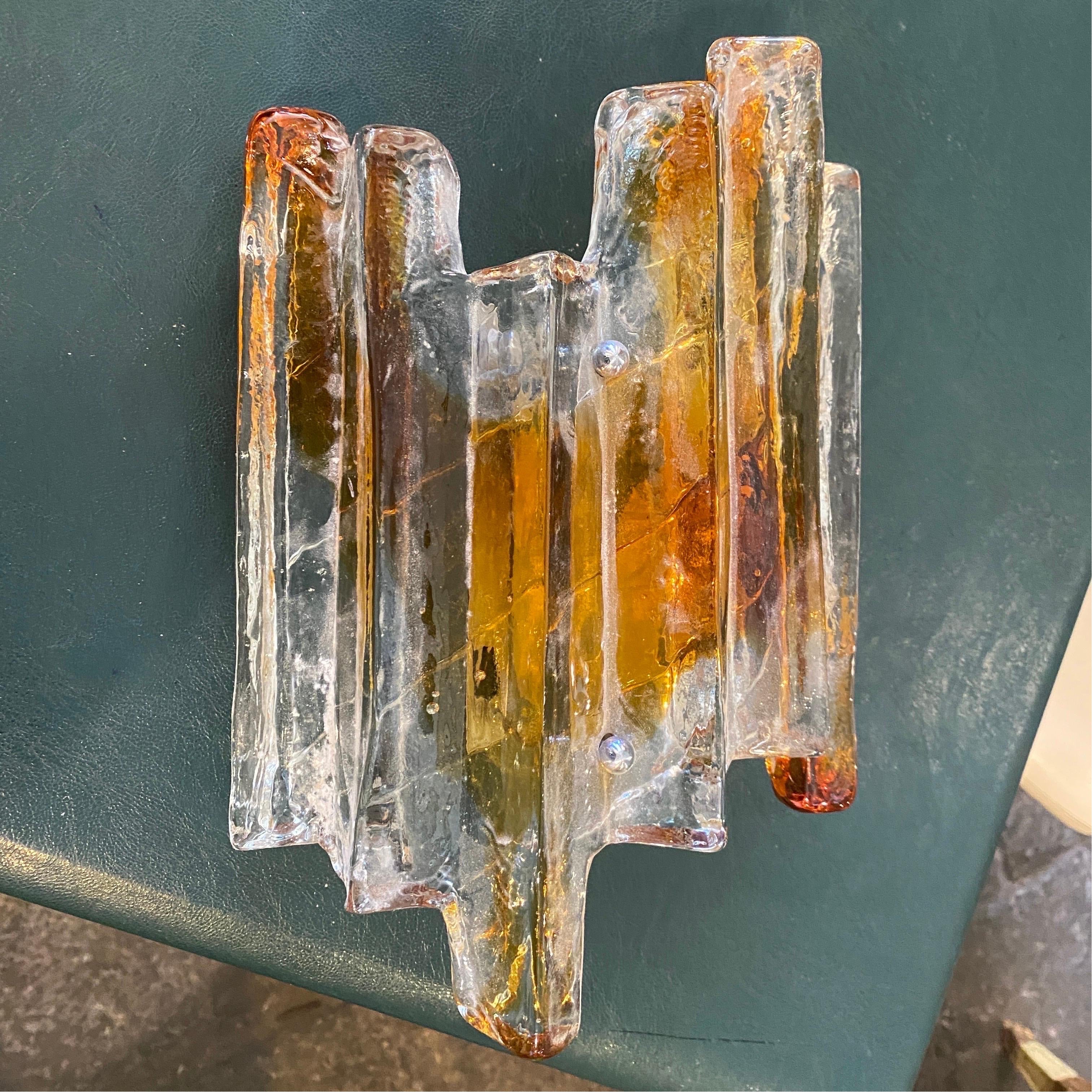 A rare amber, brown and transparent murano glass single wall sconce designed and manufactured in Italy in the Seventies by Mazzega, it works both 110-240 volts and it needs a regular e14 bulb.