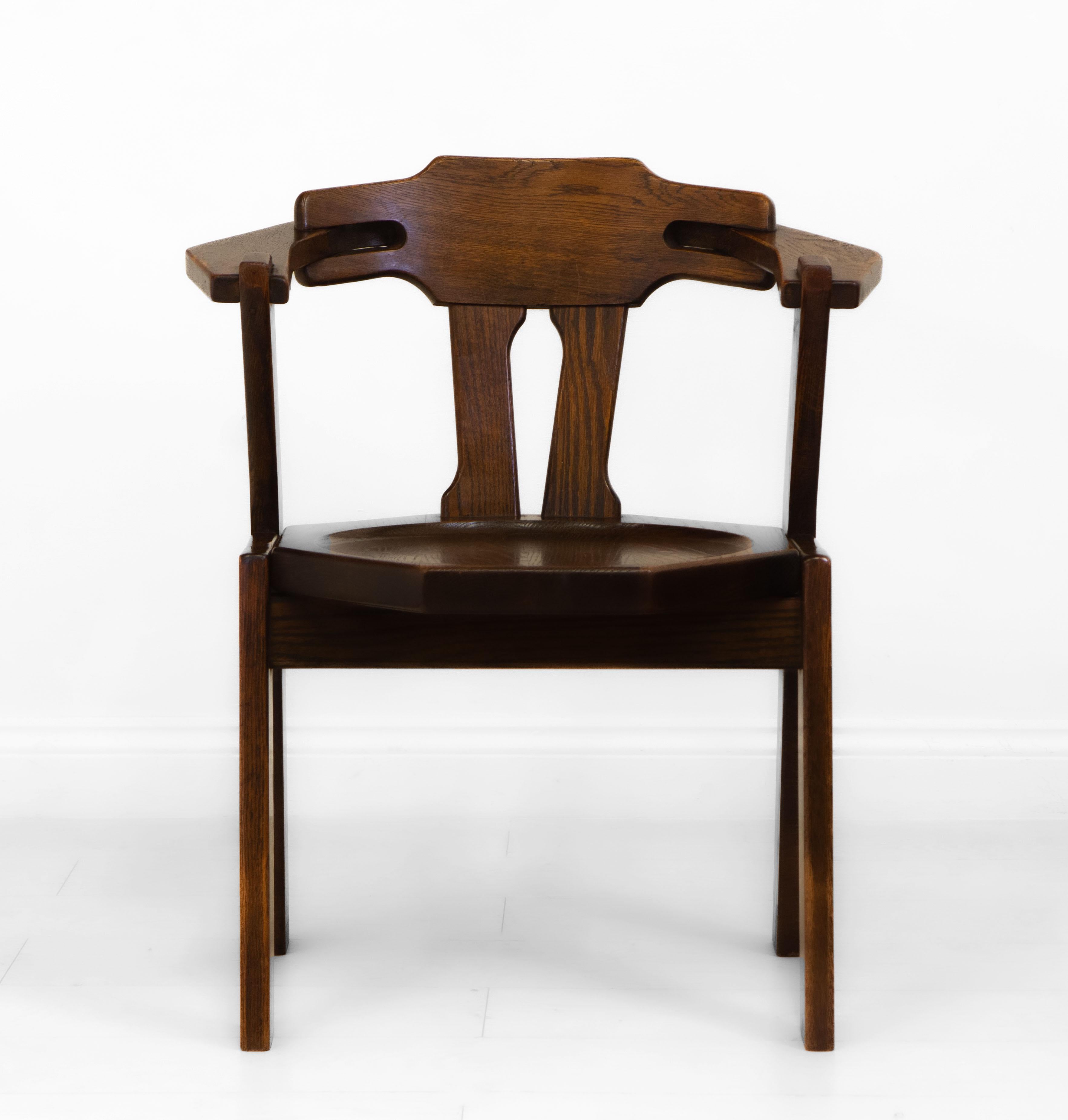 A Brutalist design oak side/desk chair. Low Countries - circa 1970.

This stylish chair is made in solid oak and in good original condition. It has been cleaned and waxed. There is some colour loss to the arms from use, a mark to the dished seat,