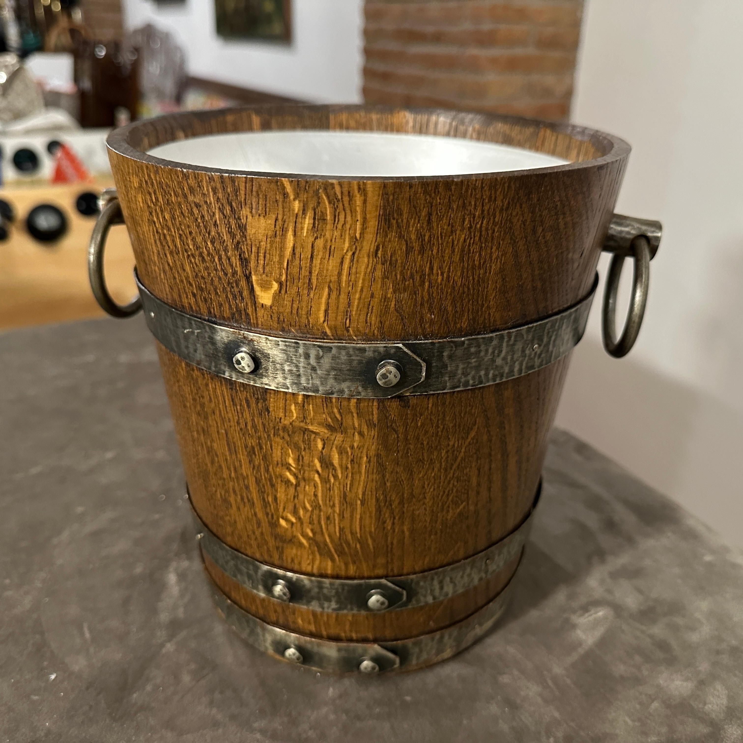 An amazing oak and wrought iron wine cooler hand-crafted in France in the Seventies, it's in original condition with normal signs of use and age, It exhibits characteristics of the Brutalist style popular during that era. Art Deco featured geometric